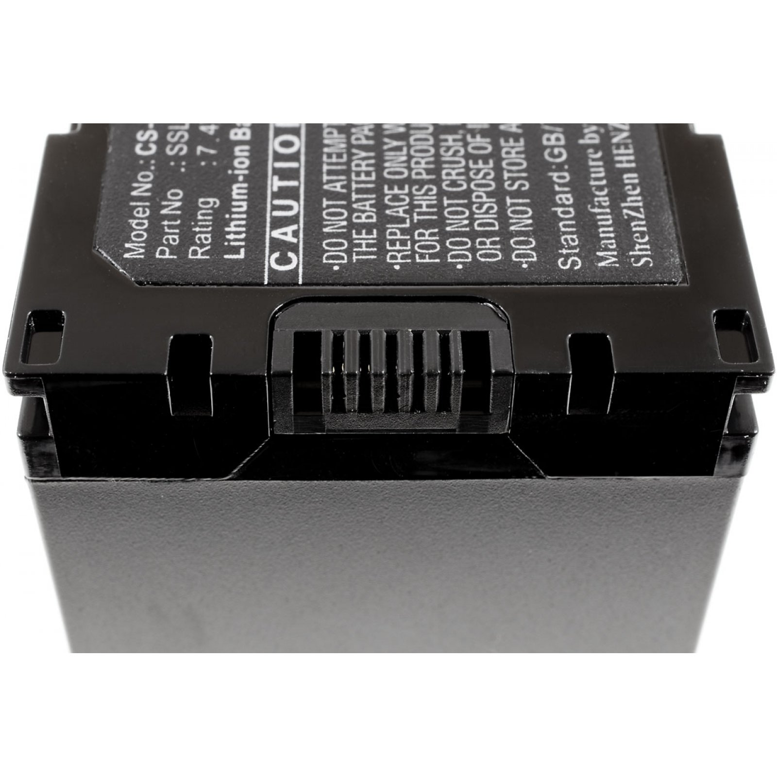 Parte trasera de una batería negra con conector y etiqueta de advertencia.