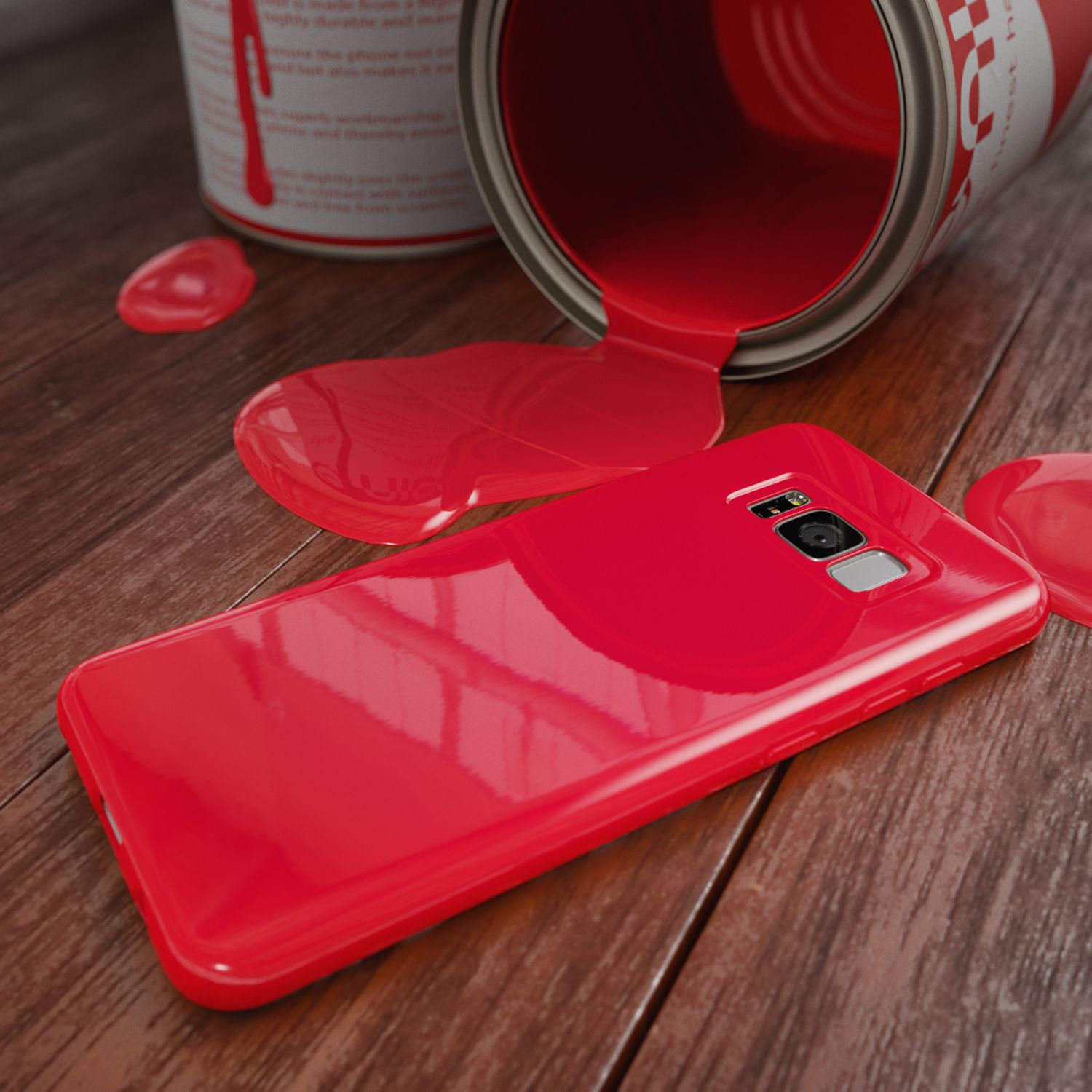 Eine rote Handyhülle mit verschütteter roter Farbe und eine Farbdose auf einer Holzoberfläche.