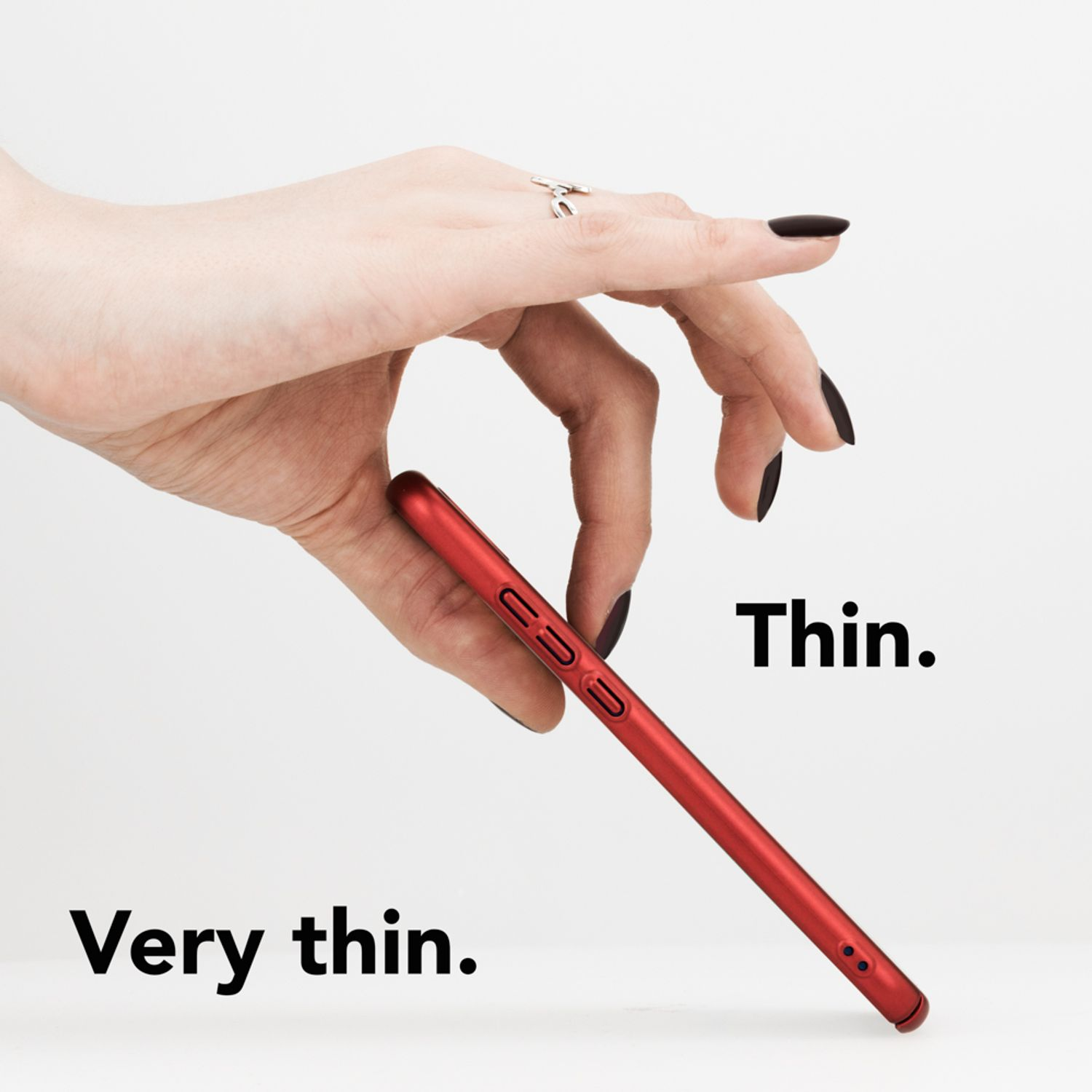 Ein dünnes, rotes Telefon wird in einer Hand mit schwarzem Nagellack gehalten. Text: Dünn, sehr dünn.