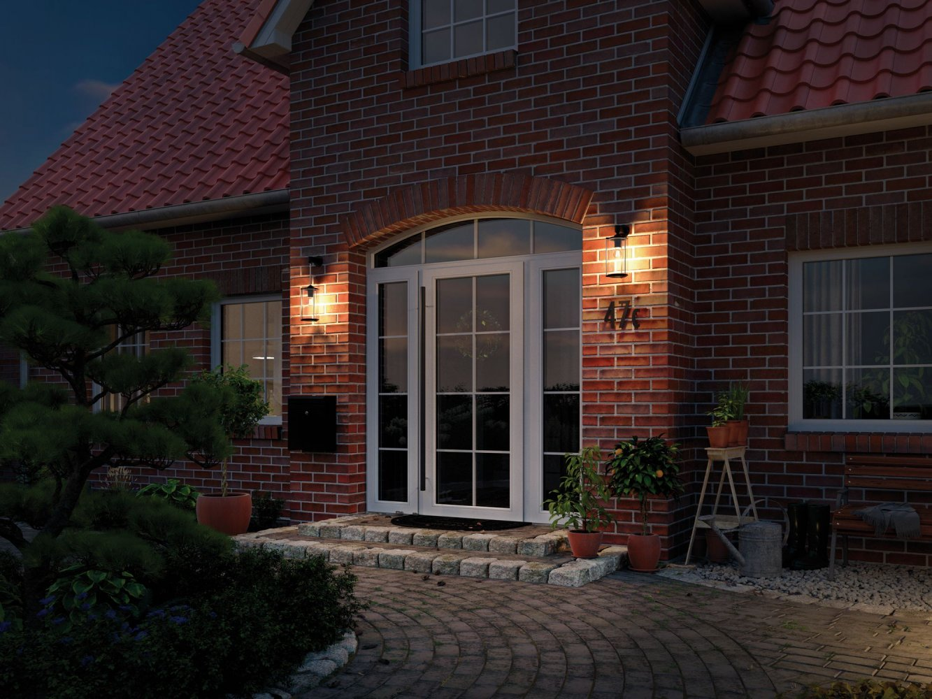Nocna scena z ceglanym domem, oświetlonym wejściem, oknami i czerwonym dachem.