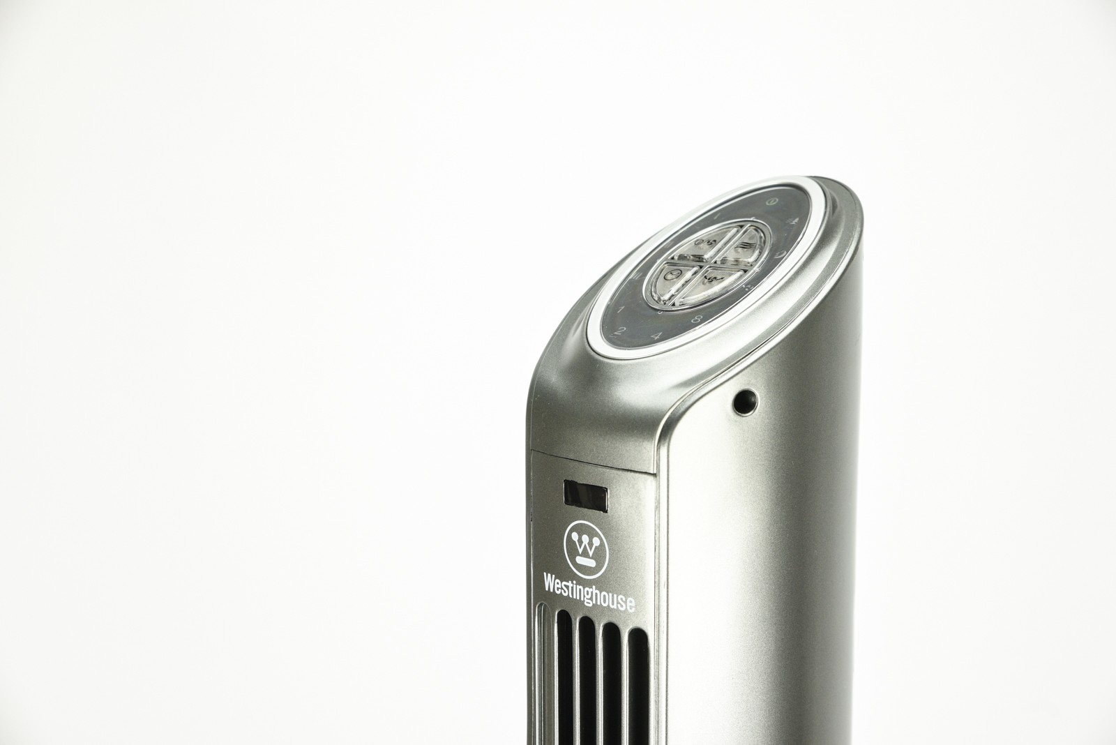 Srebrny wentylator wieżowy z elementami sterującymi na górze, marką "Westinghouse" z przodu, białe tło.