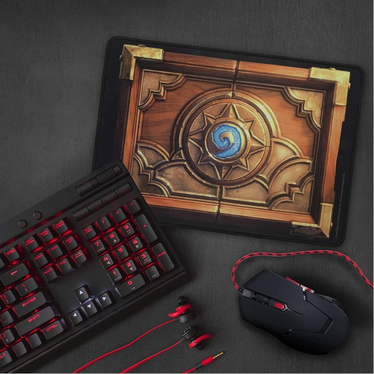 Configuration de jeu avec clavier, souris et tapis de souris. Le tapis a un design en bois.