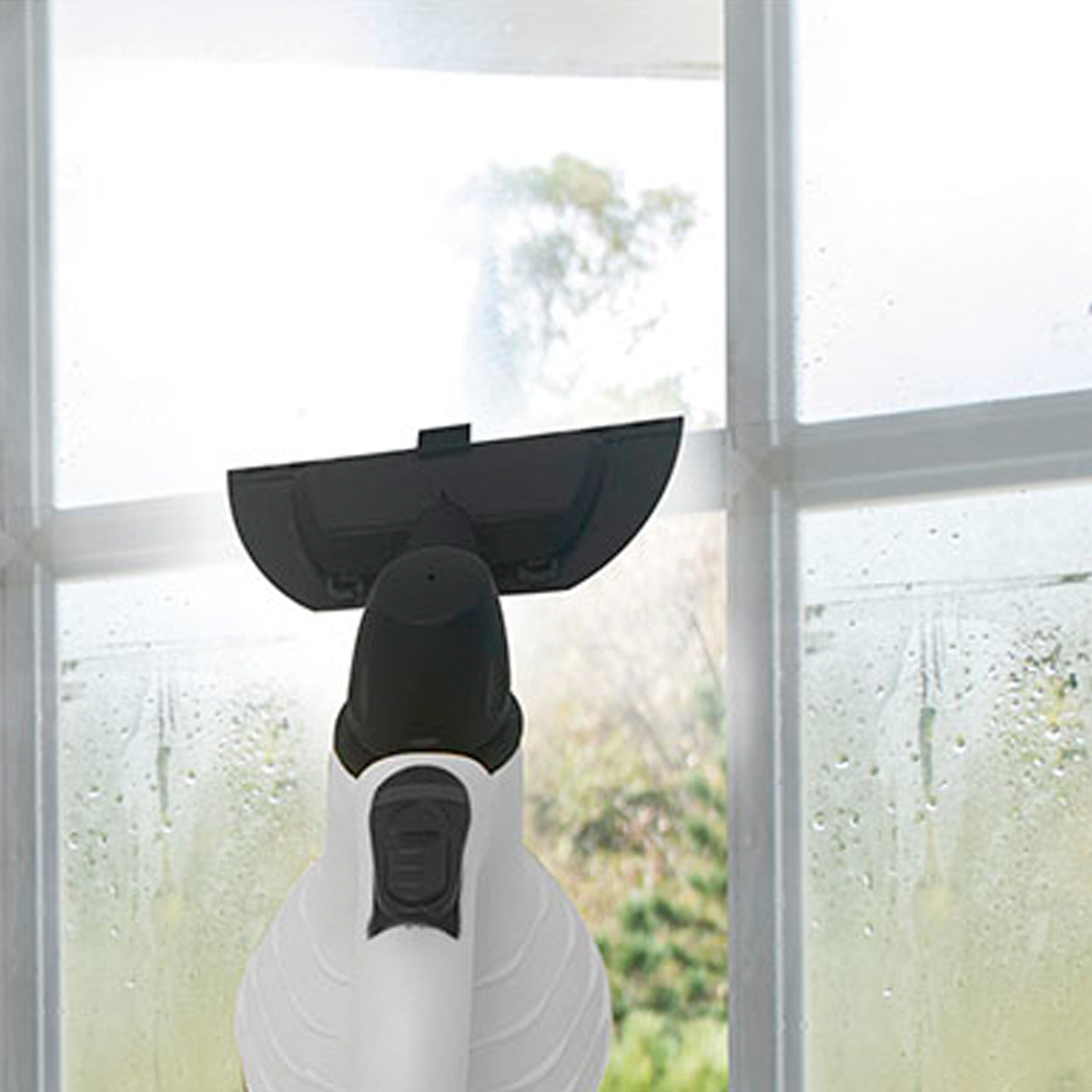 Un nettoyeur vapeur blanc et noir nettoyant une fenêtre. La fenêtre a de l'eau.