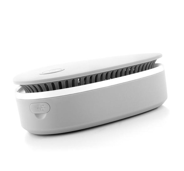 Un deodorante per ambienti grigio chiaro. È rettangolare con una porta USB. Ha un design a fessure.