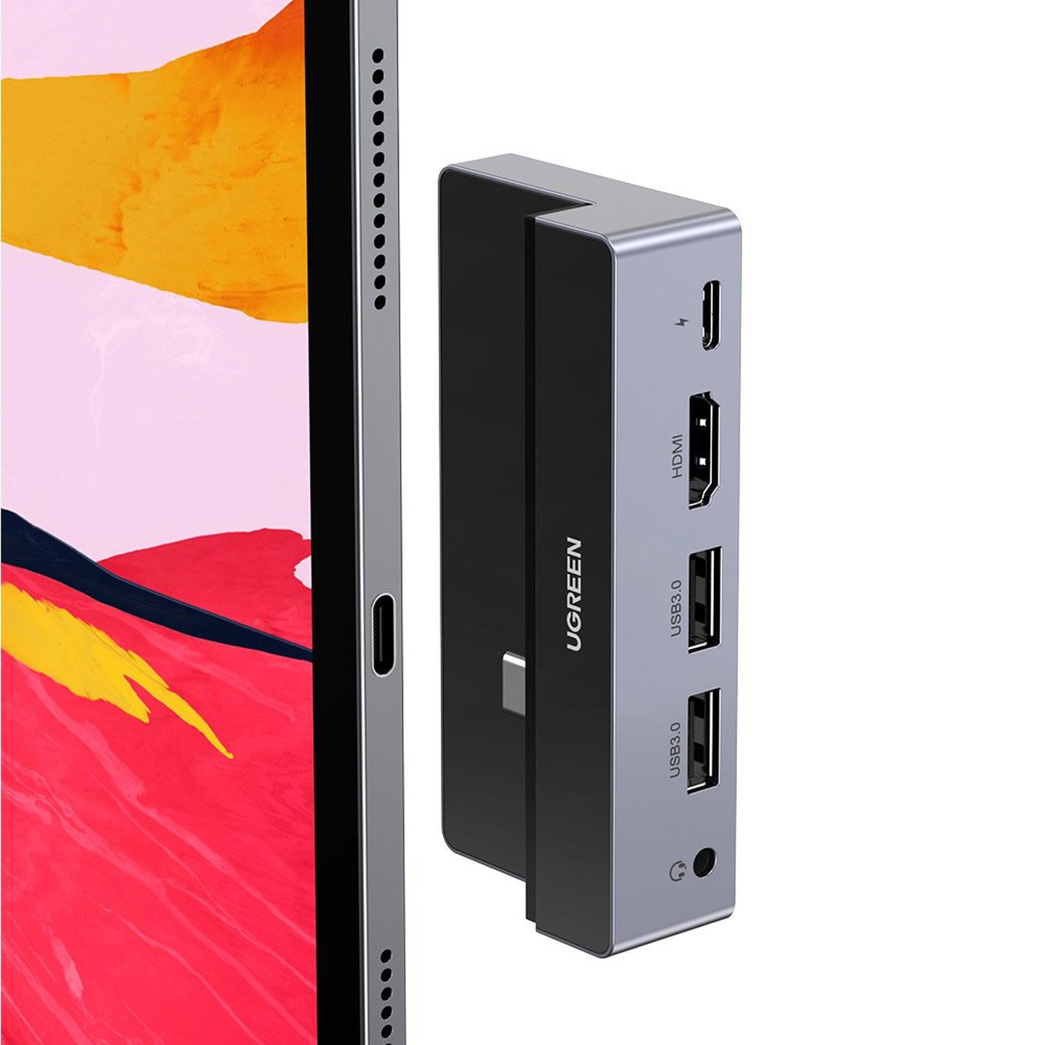 A silver and black UGREEN USB-C hub connected to a tablet.
