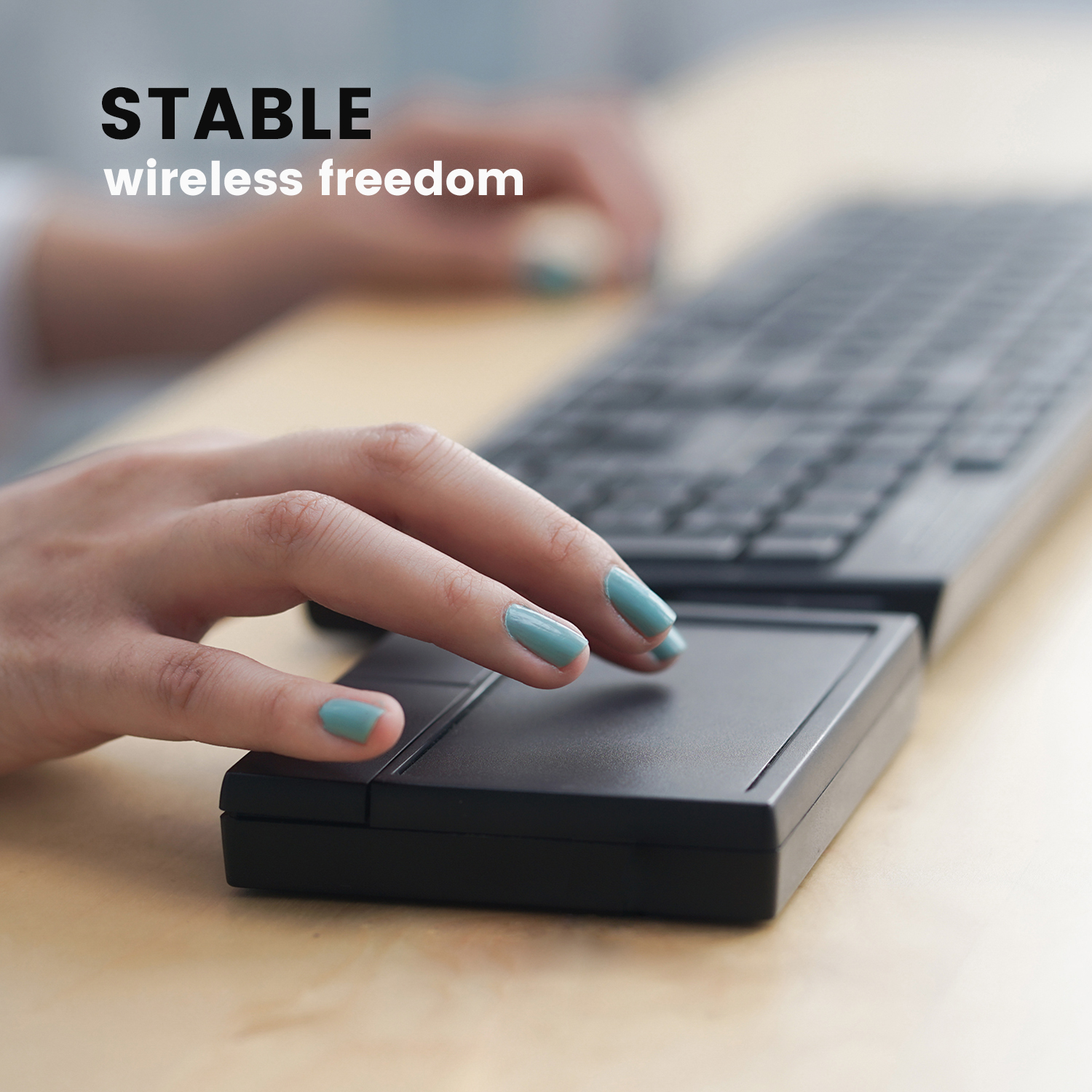 Dłoń kobiety na czarnej klawiaturze z czarnym panelem dotykowym. Tekst mówi: 'STABLE wireless freedom'.