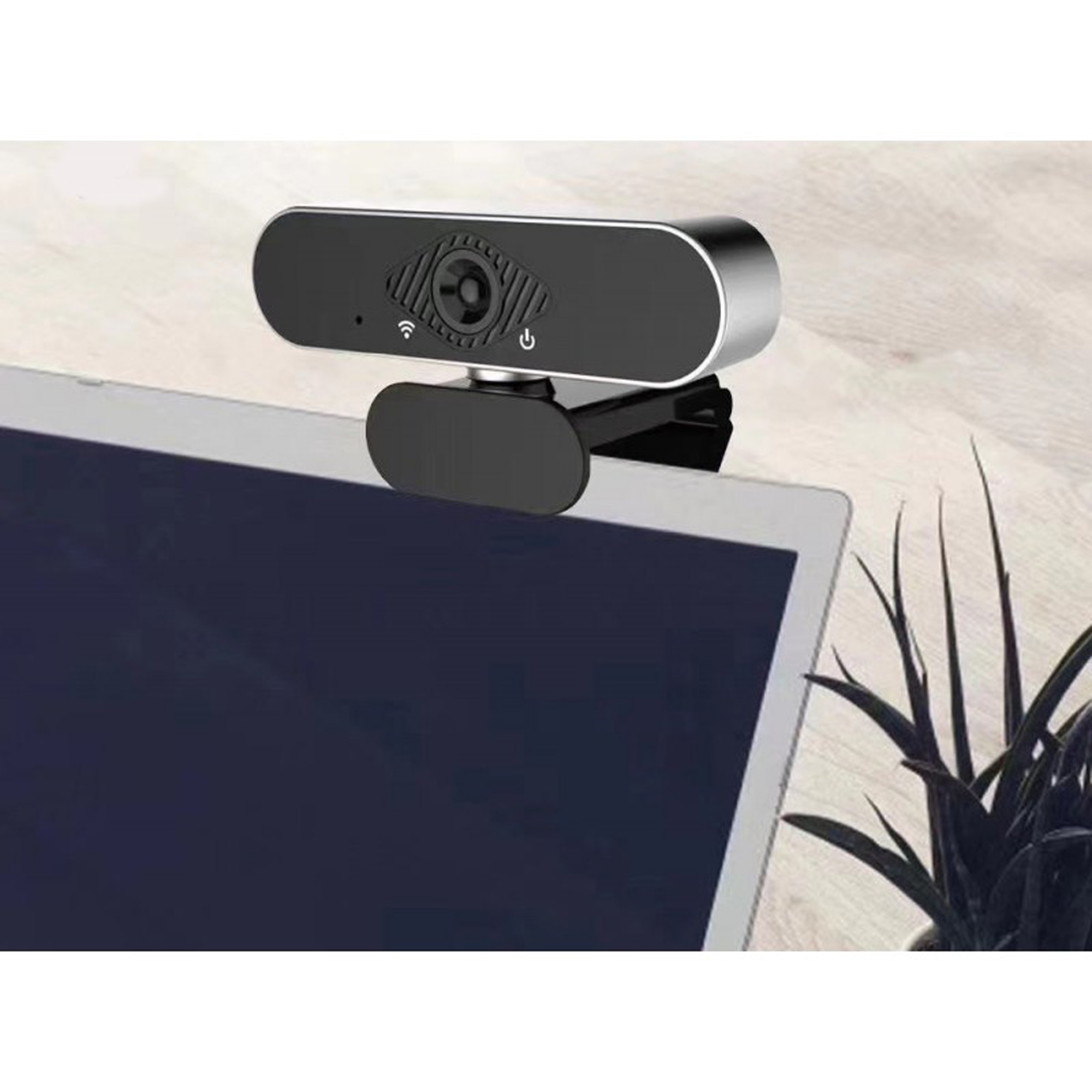 Eine Webcam auf einem Laptop. Die Webcam ist schwarz und silber. Sie ist am Laptop-Bildschirm befestigt.