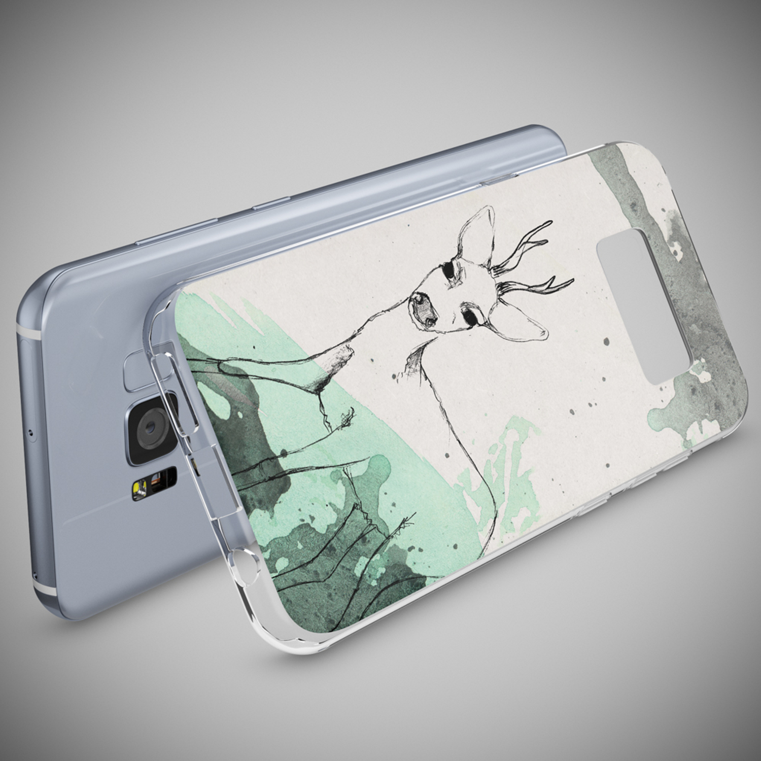 Funda de teléfono con un dibujo de ciervo y salpicaduras de acuarela verde. Teléfono detrás. Fondo gris.