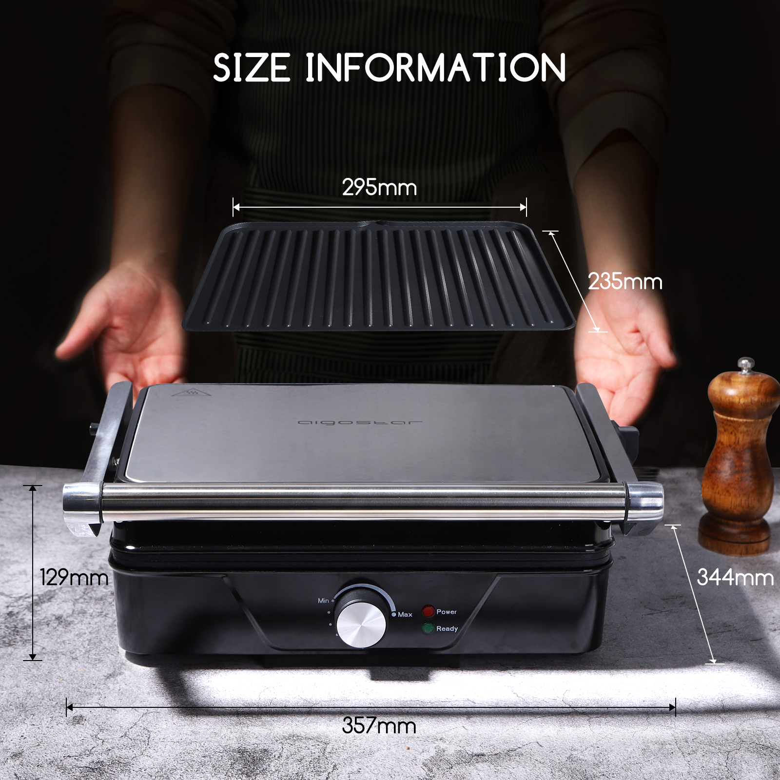 Ein geschlossener Grill mit Abmessungen. Der Grill ist schwarz mit silbernem Griff und herausnehmbarer Kochplatte.