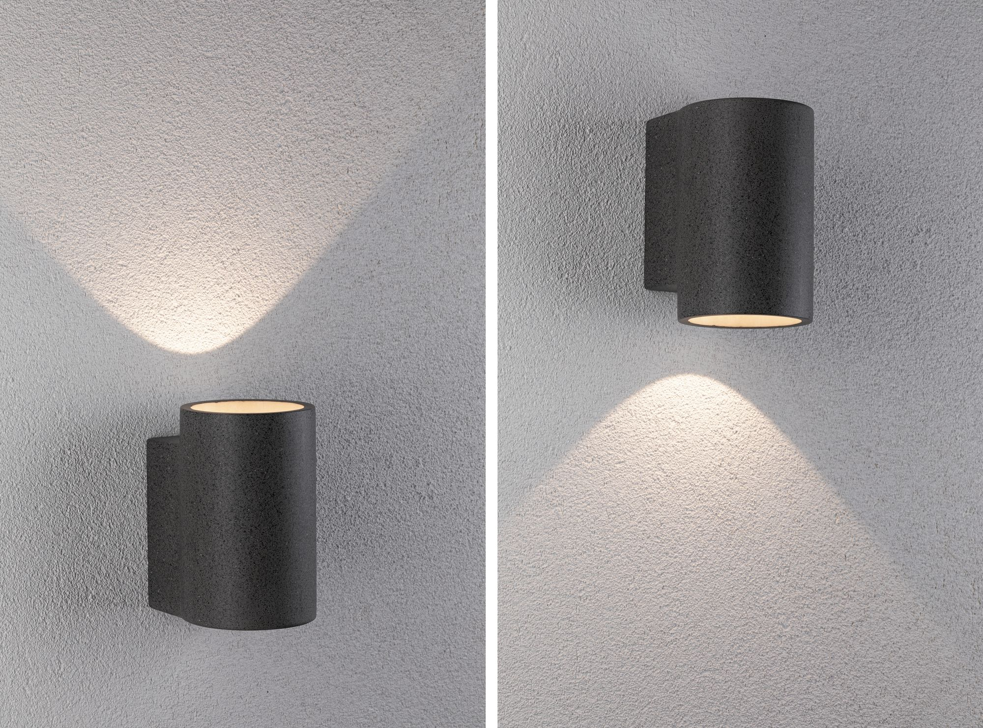 Dwa ciemnoszare cylindryczne kinkiety, emitujące światło w dół na ścianę.