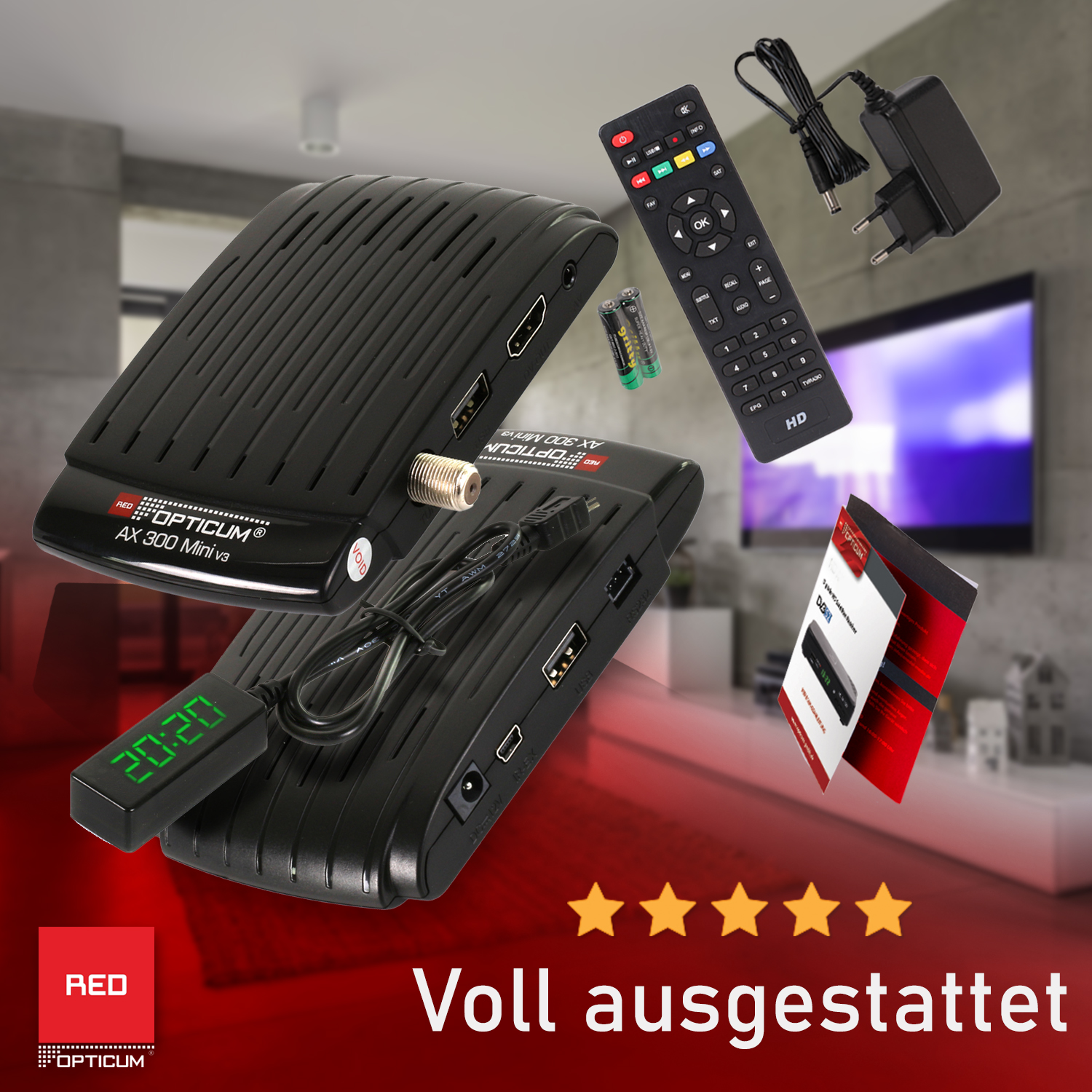 Schwarze TV-Box mit Fernbedienung, Kabeln und Zubehör auf weißem Tisch.