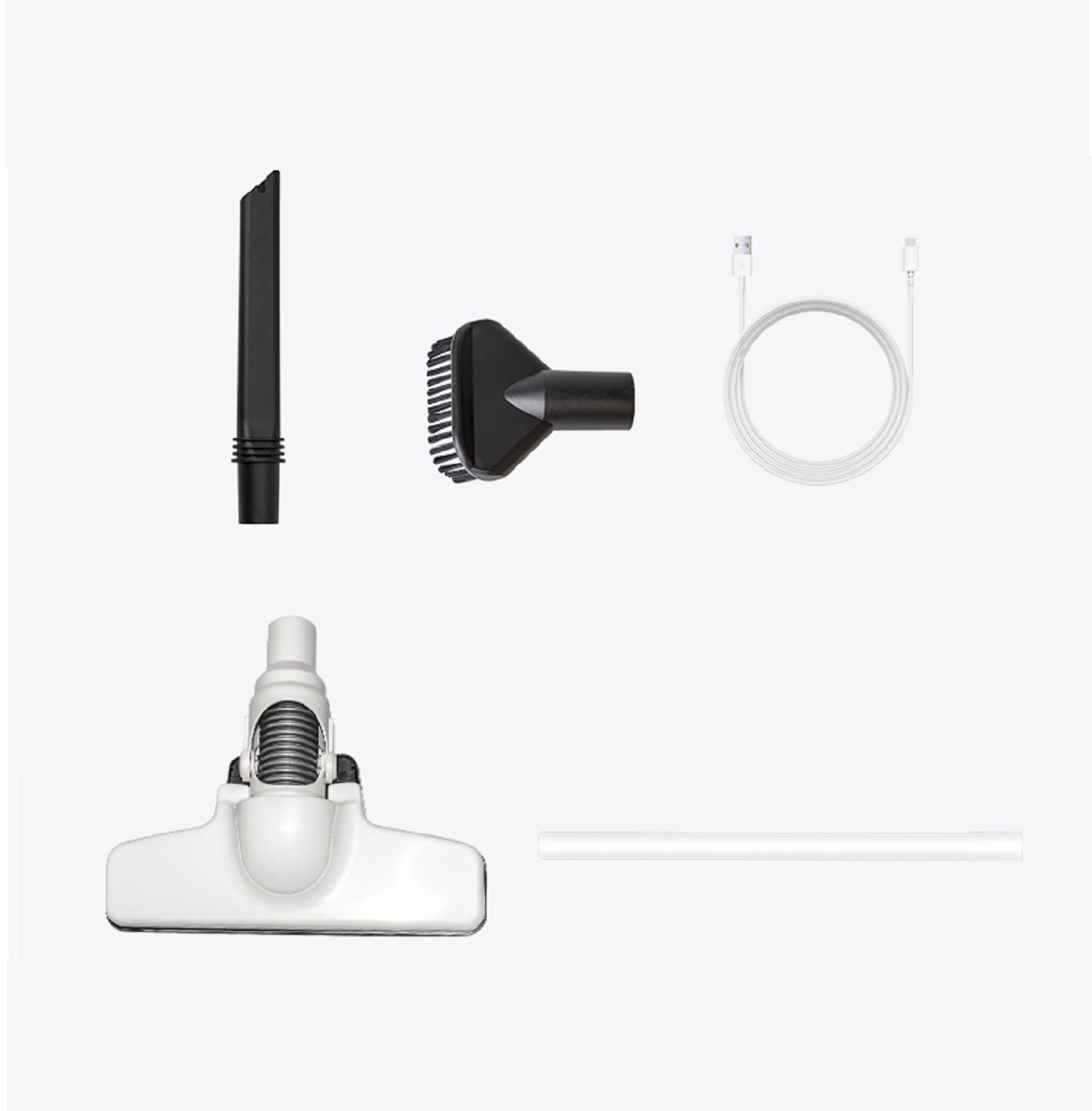 Verschiedene Staubsaugeraufsätze, darunter ein Fugendüse, eine Bürste und ein USB-Kabel.