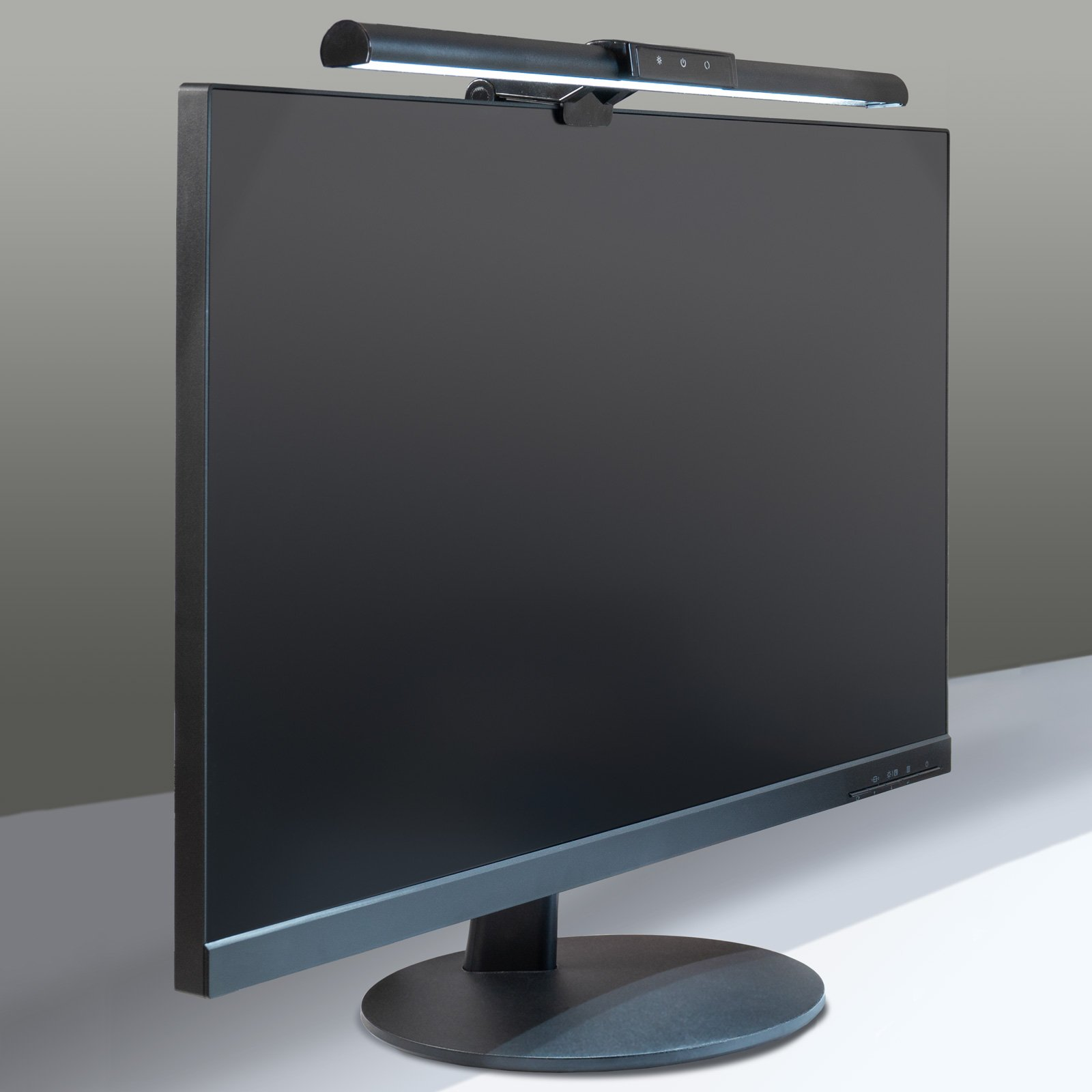 Schwarzer Computermonitor mit einer Schreibtischlampe. Der Hintergrund ist ein Farbverlauf.