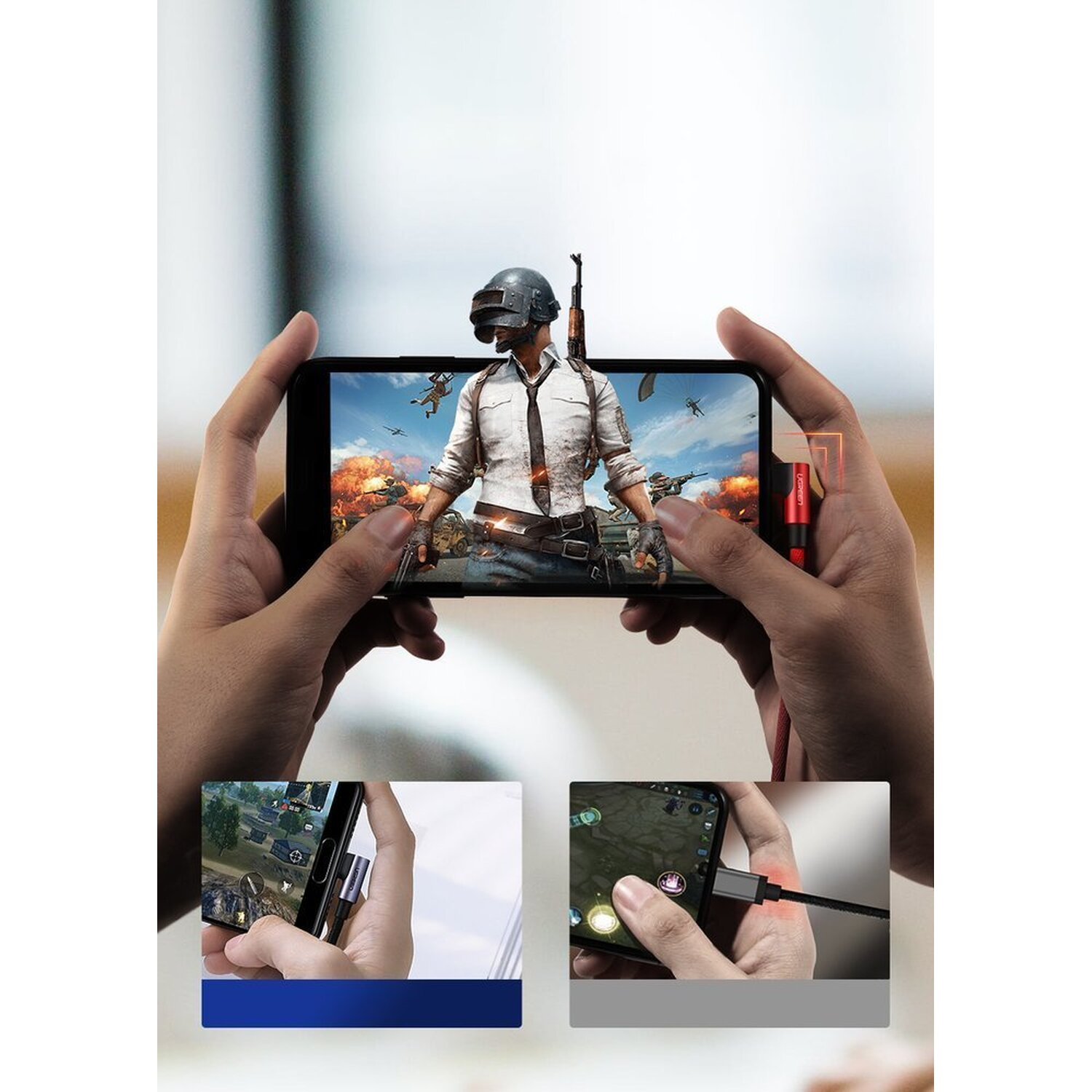 Hände, die ein Telefon halten, das ein Videospiel mit einem angeschlossenen roten Adapter anzeigt.