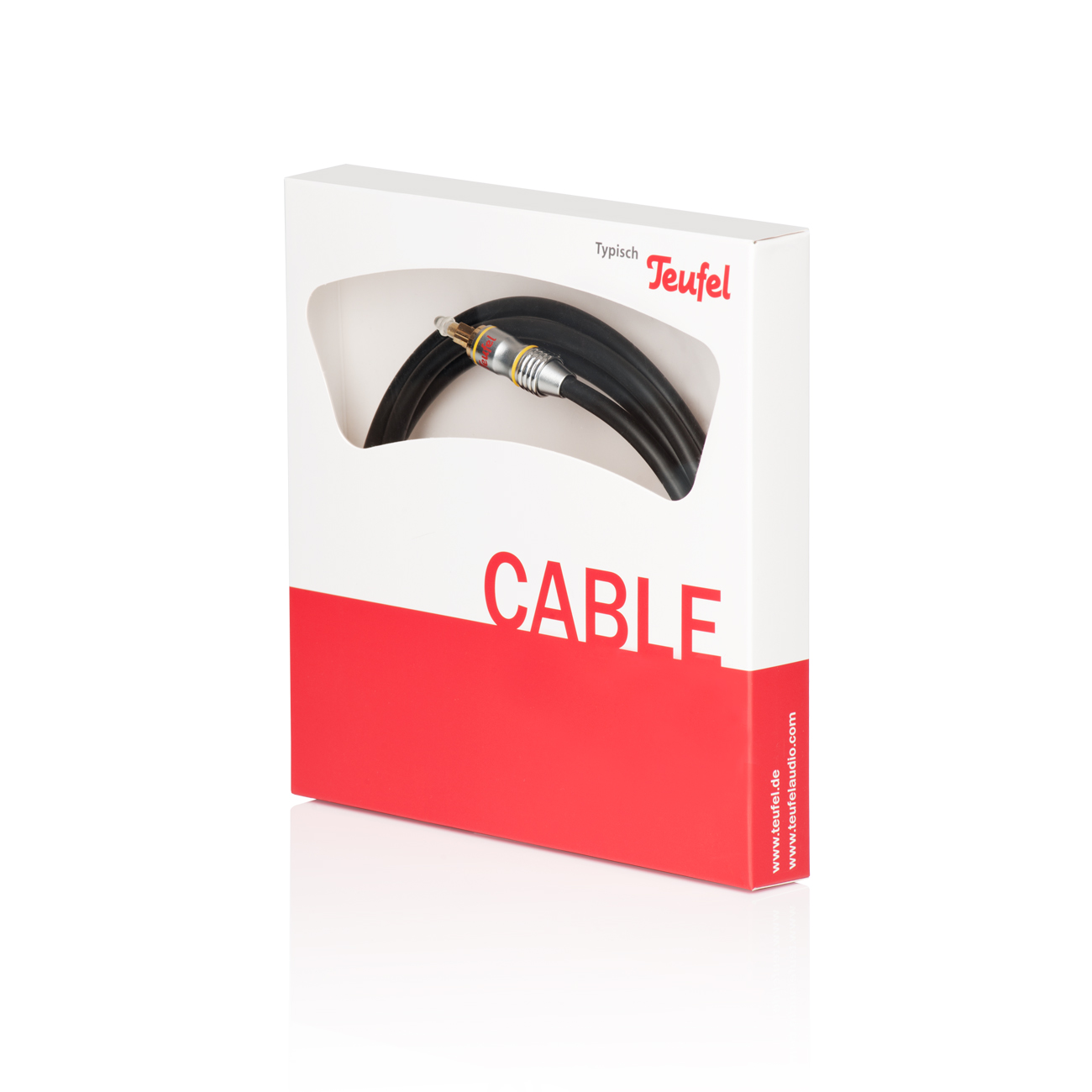 Weiße Box mit schwarzem Kabel. Roter Boden. Teufel Logo oben.