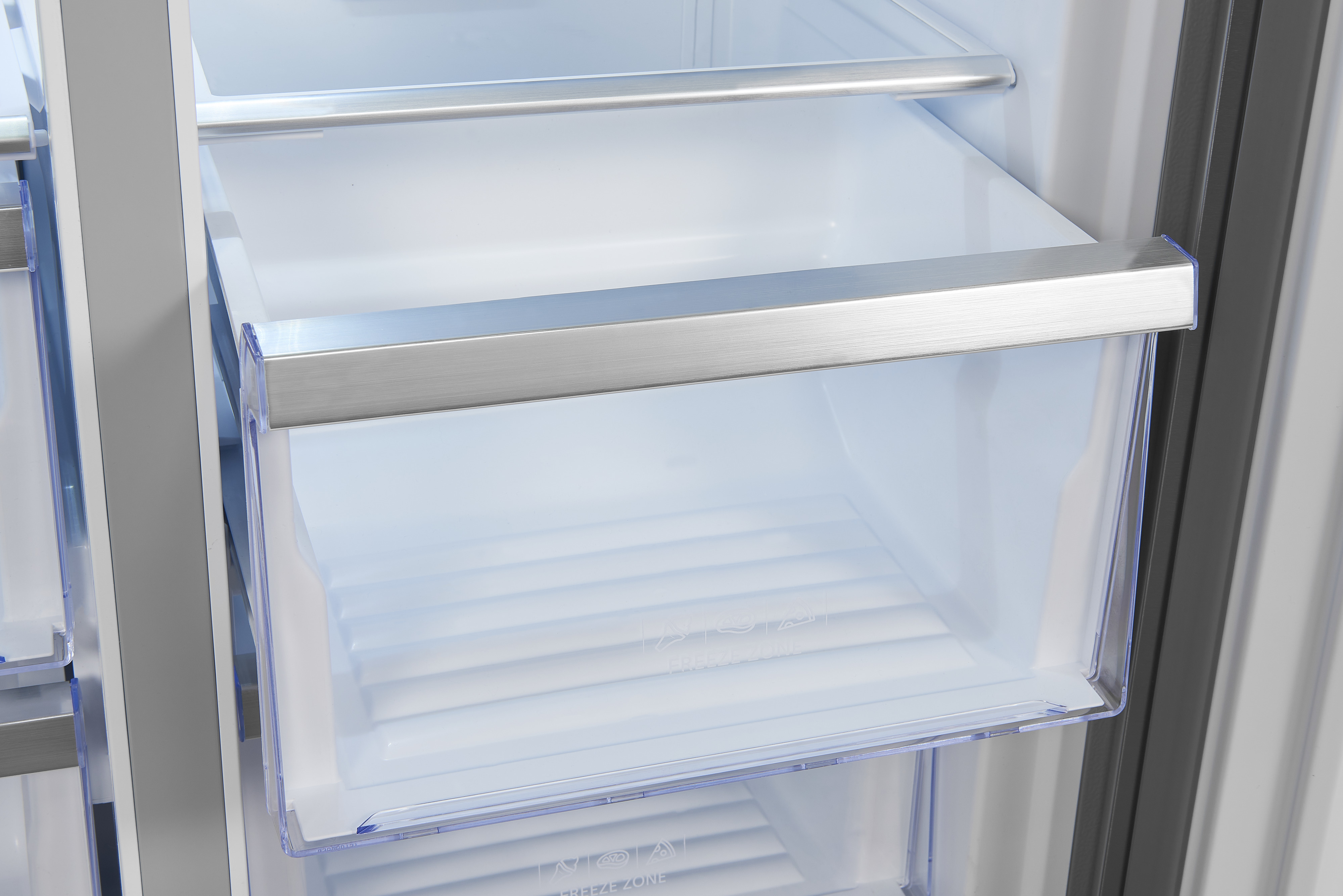 Nahaufnahme einer Kühlschrank-Schublade. Sie ist transparent, mit einem silbernen Griff.