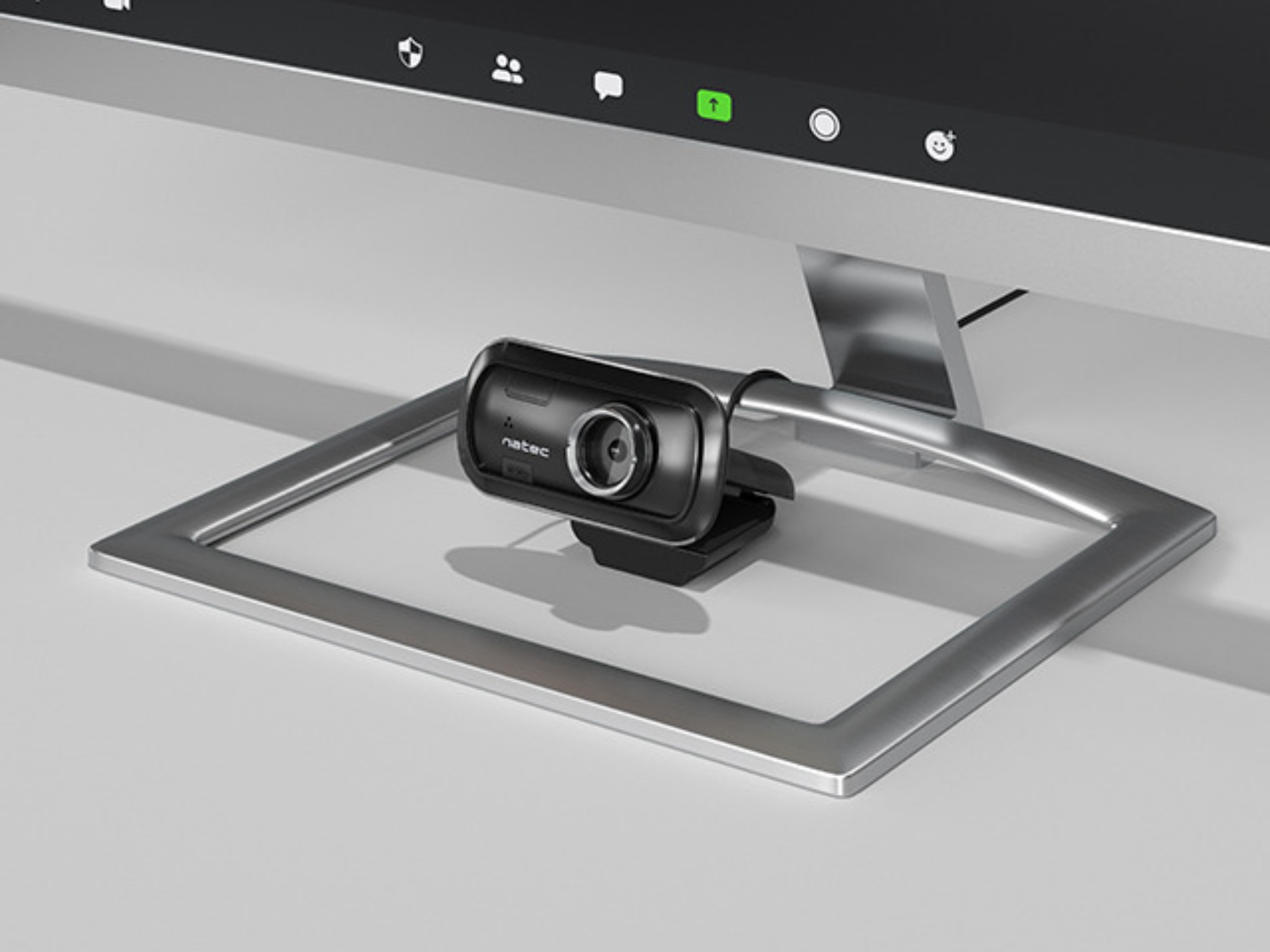 Czarna kamera internetowa przymocowana do monitora, ekran wyświetla ikony aplikacji.