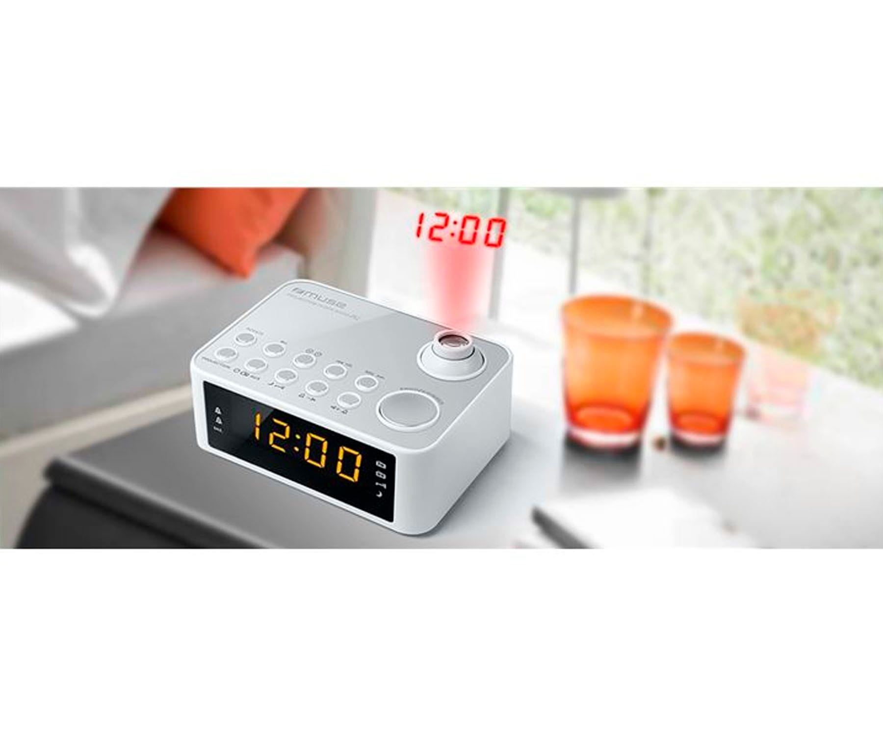 Biały budzik z wyświetlaczem cyfrowym. Pomarańczowe szklanki w tle. Białe tło.