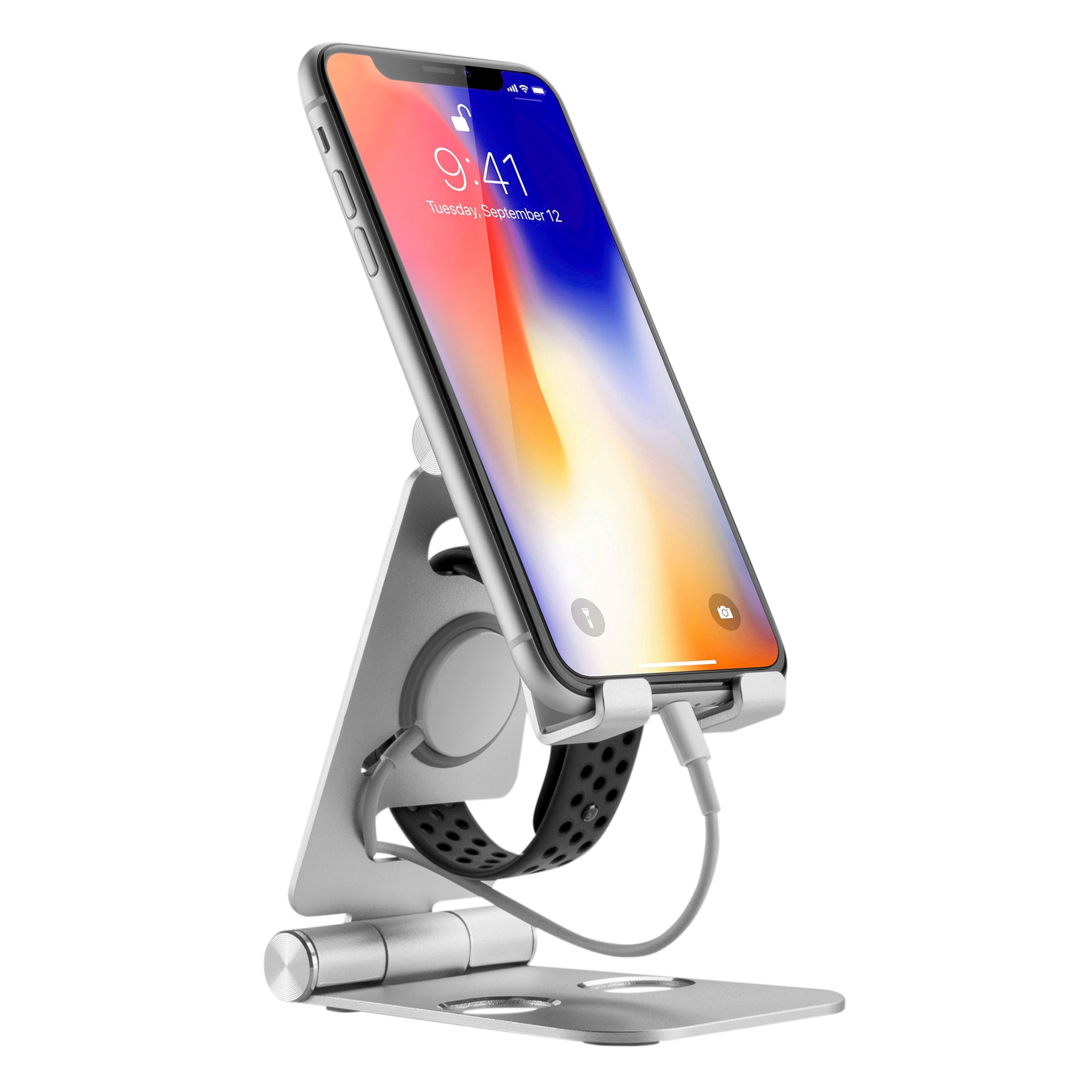 Un soporte plateado para teléfono con un teléfono y un reloj negro conectado. El teléfono muestra un símbolo de carga.
