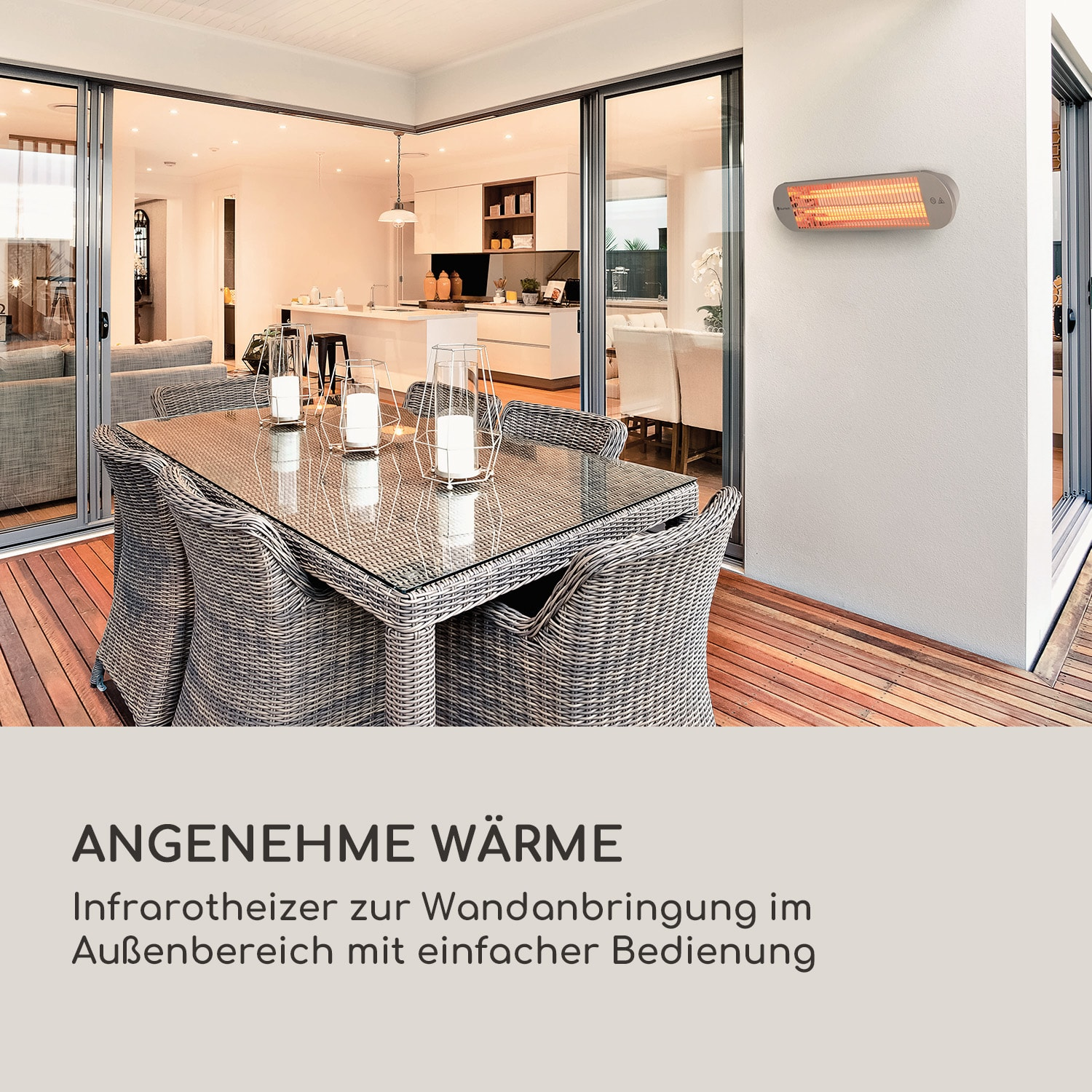 Außenterrasse mit Infrarotheizung, Tisch mit Kerzen und Blick auf das Haus.
