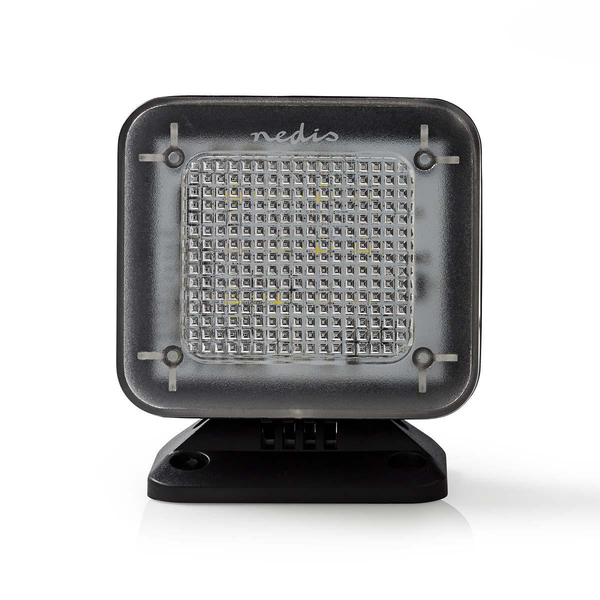 Eine quadratische schwarze LED-Leuchte mit transparentem Deckel auf schwarzem Sockel. Der Hintergrund ist weiß.
