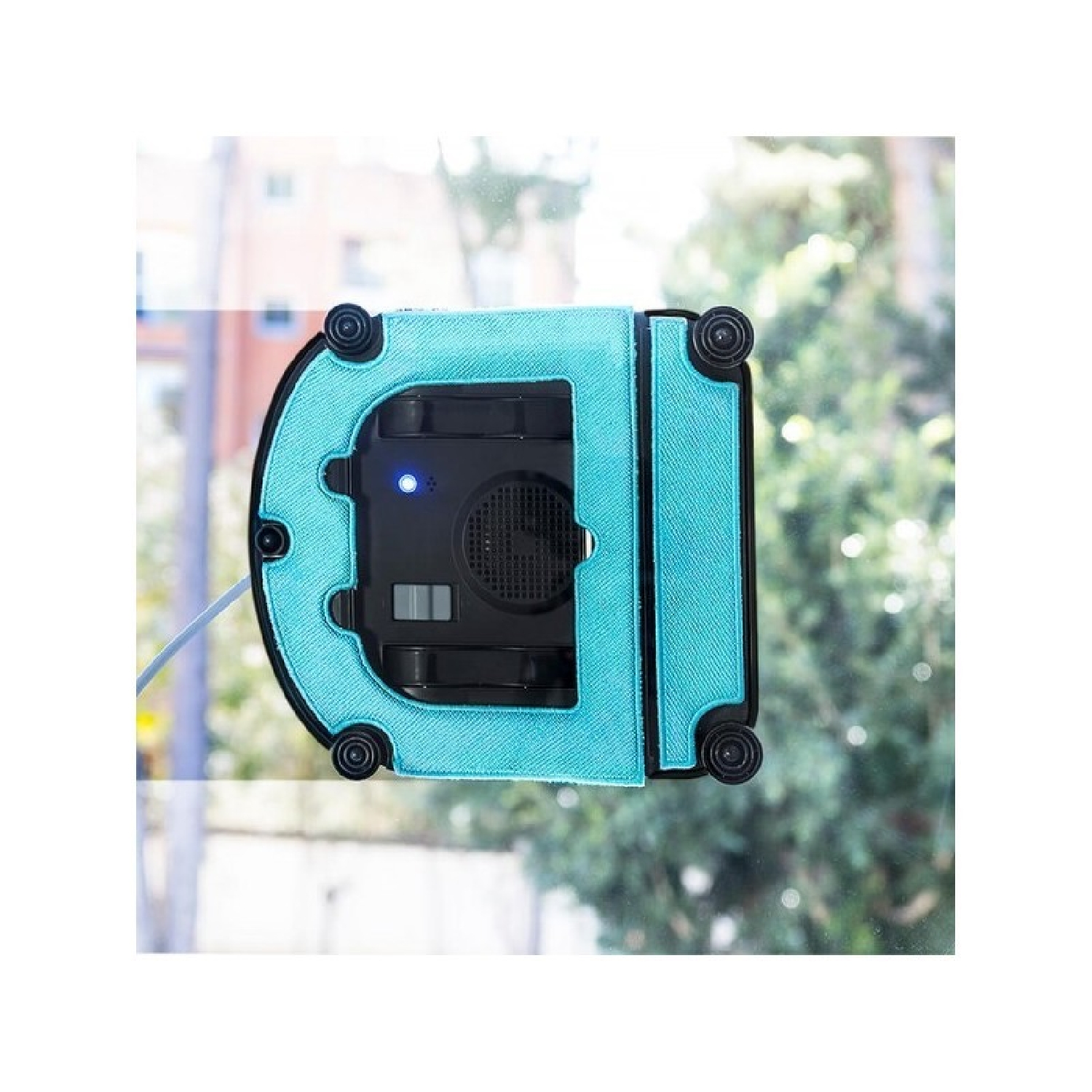 Robot limpiacristales sobre vidrio. Paño azul y cuerpo negro. Vista exterior.
