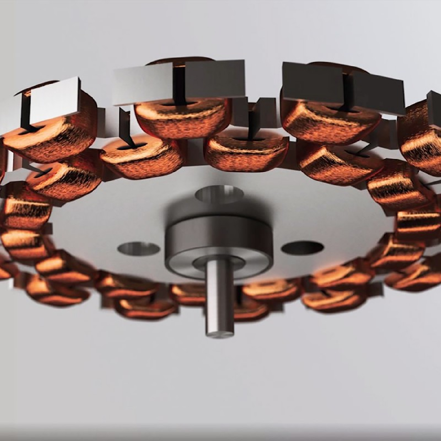 Zbliżenie elementu maszyny. Miedziane cewki otaczają centralną piastę. Tło jest rozmyte.