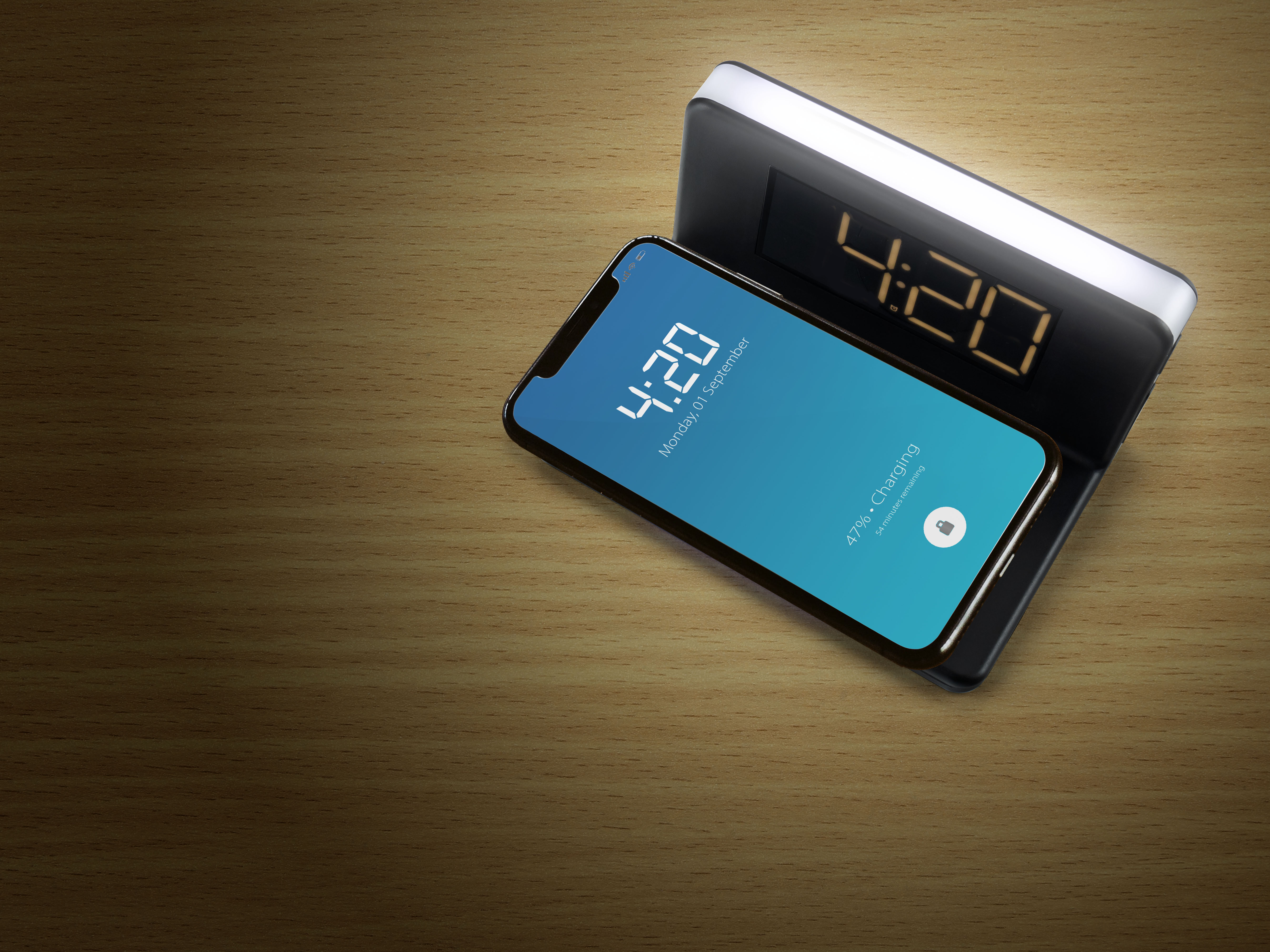 Phone on a wooden surface shows the time 4:20 and the charging notification at 47%.