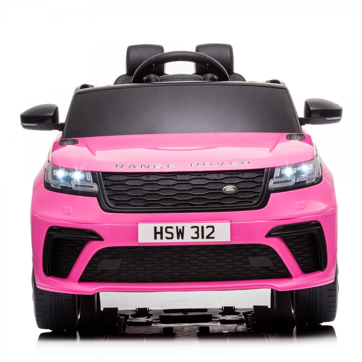 SUV Range Rover de juguete rosa. Tiene faros funcionales y una placa que dice 'HSW 312'.
