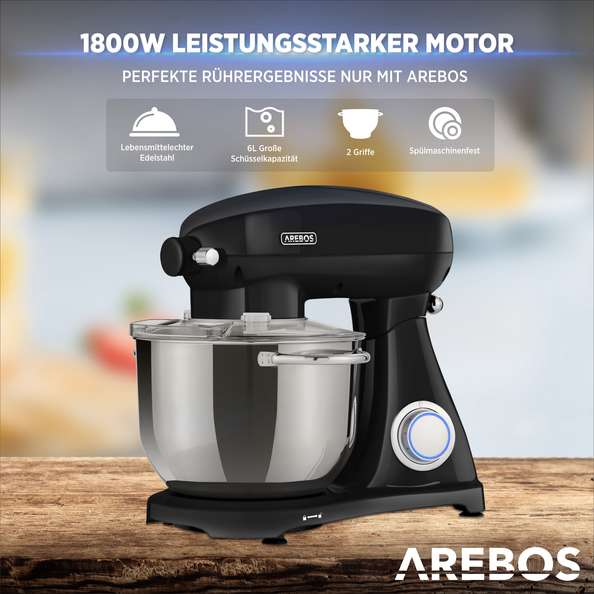 Schwarz-silberner Küchenmixer mit Edelstahl-Schüssel auf Holzoberfläche.