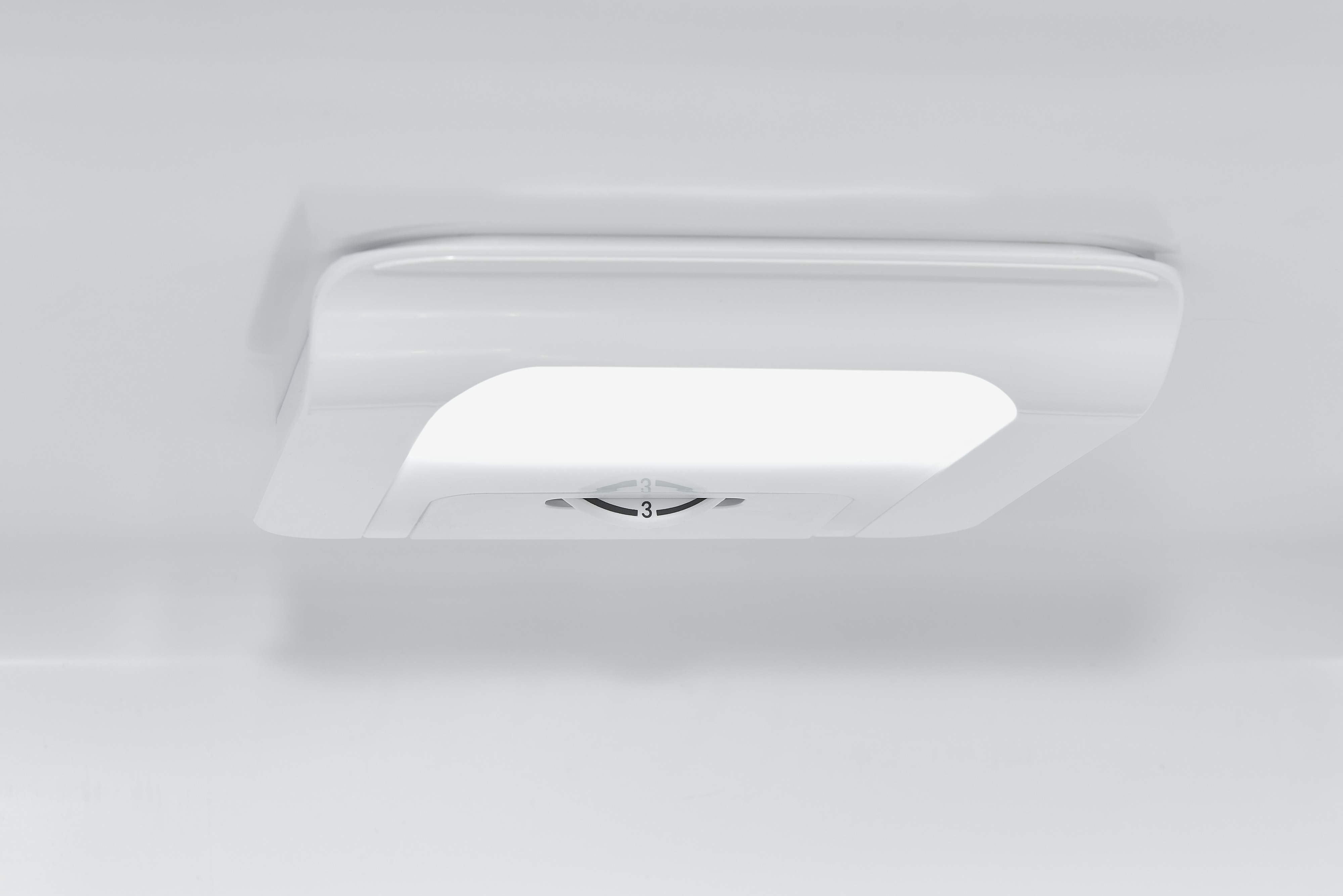White interior of a refrigerator with a white handle with a number '3' on it.