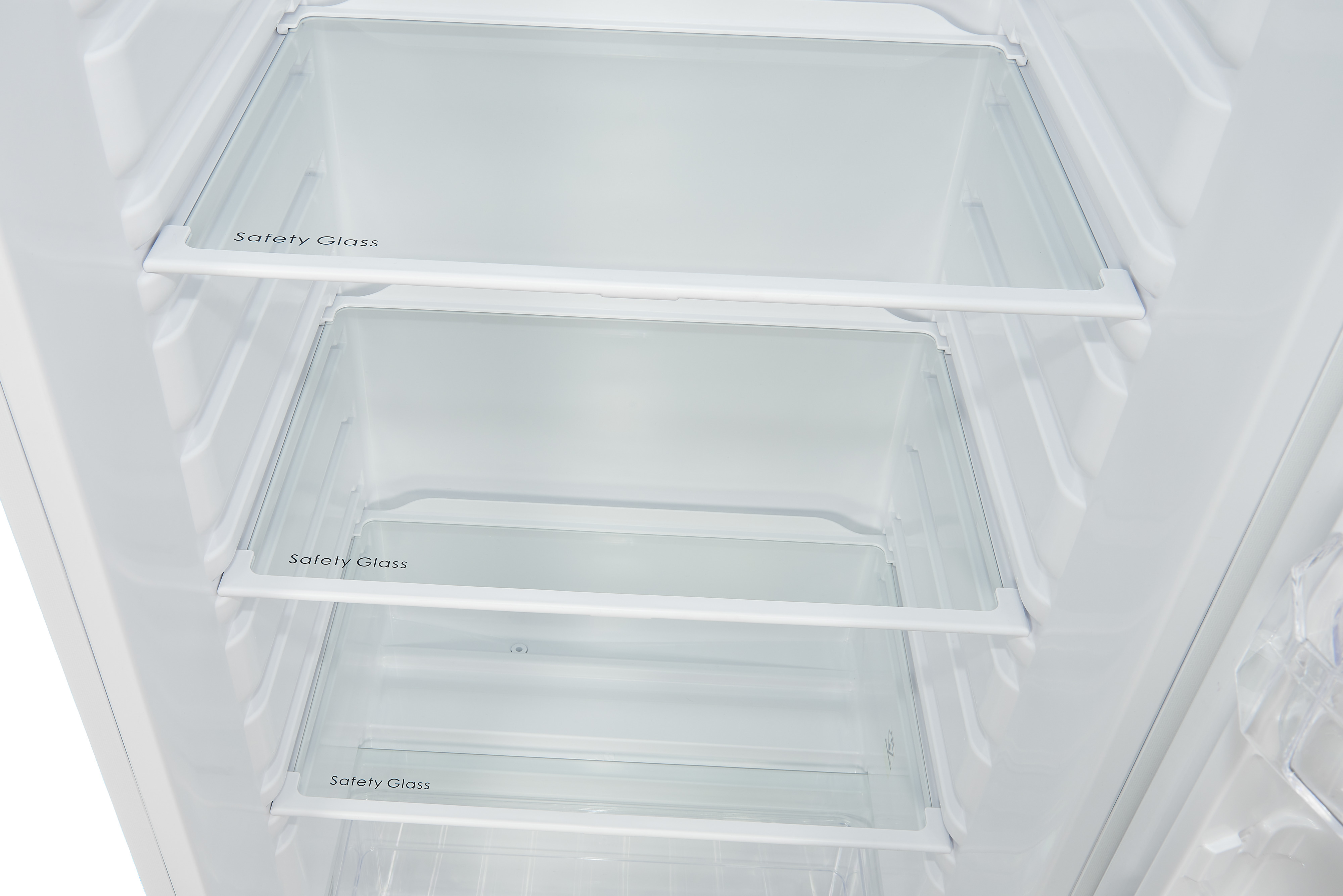 The inside of a white refrigerator showing three glass shelves and the fridge's interior.