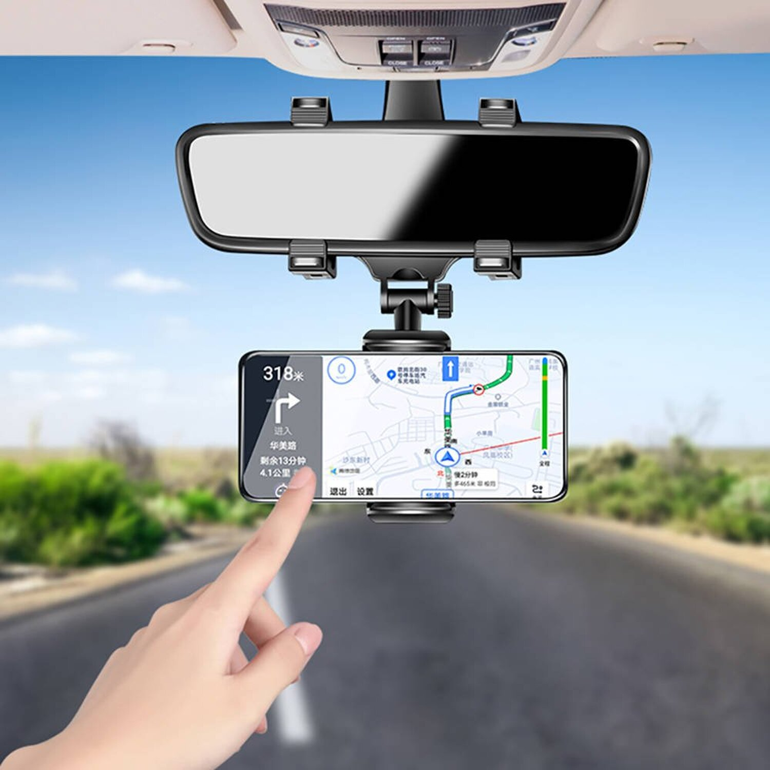 Eine Hand berührt ein Telefon in einer Autohalterung, die eine Karte zeigt, über einer Straße.