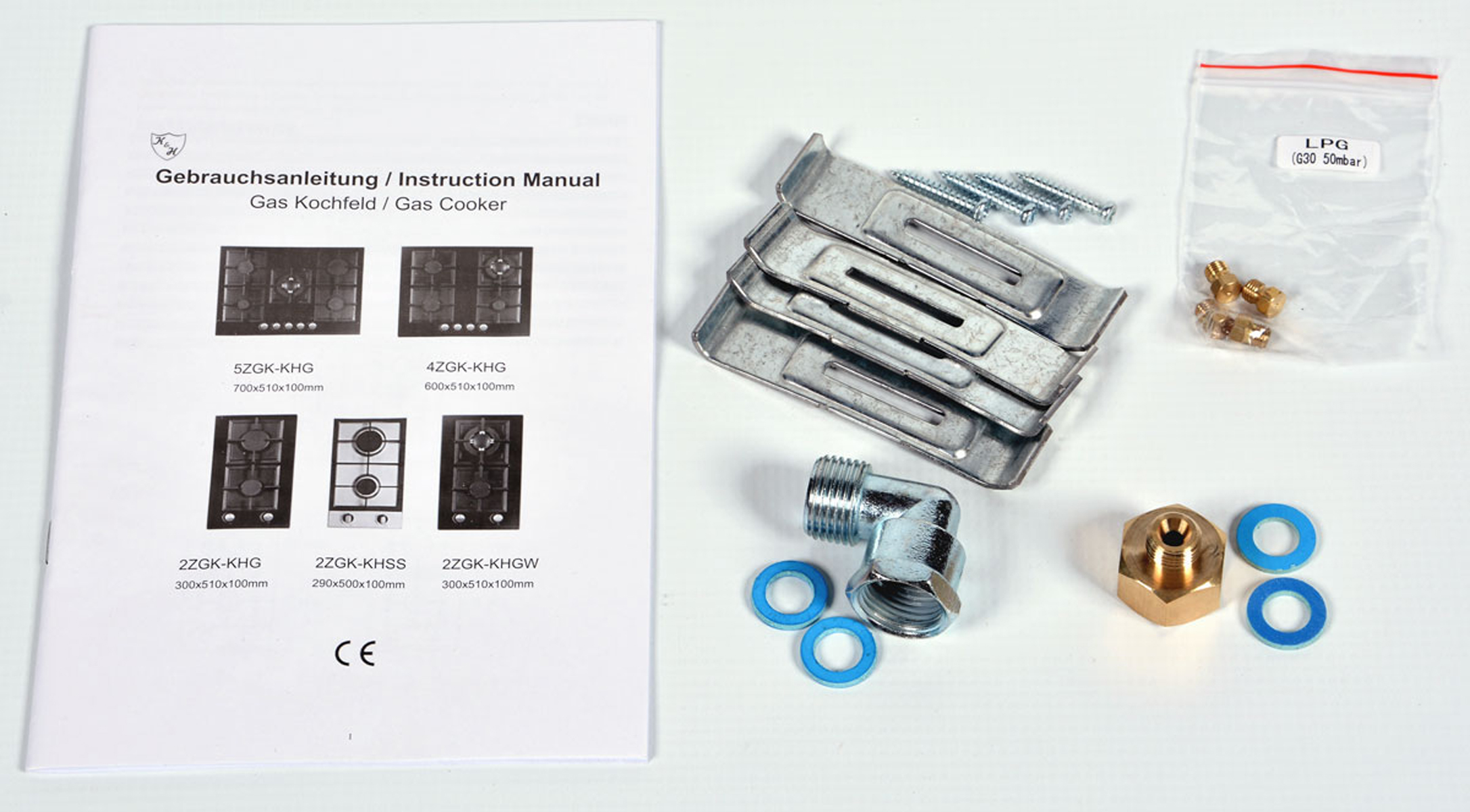 Gasherdkomponenten, Bedienungsanleitung und Hardware auf weißer Oberfläche. Enthält Kocher und Hardware.