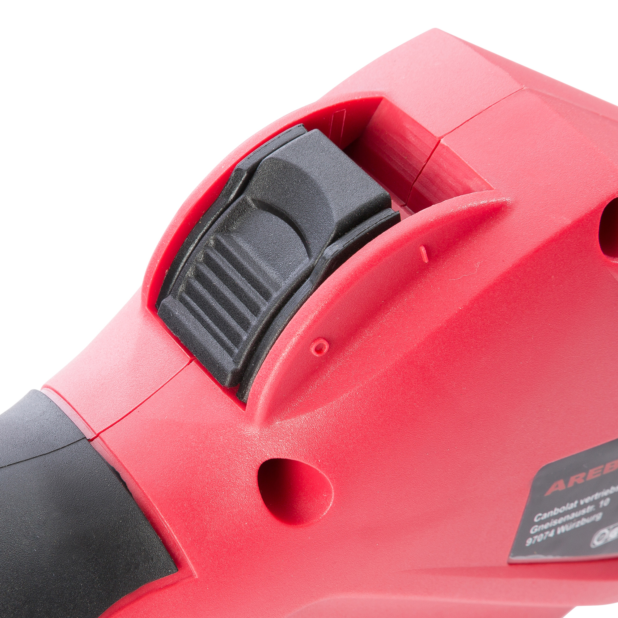 Rotes Elektrowerkzeug mit schwarzem Schalter, Nahaufnahme.