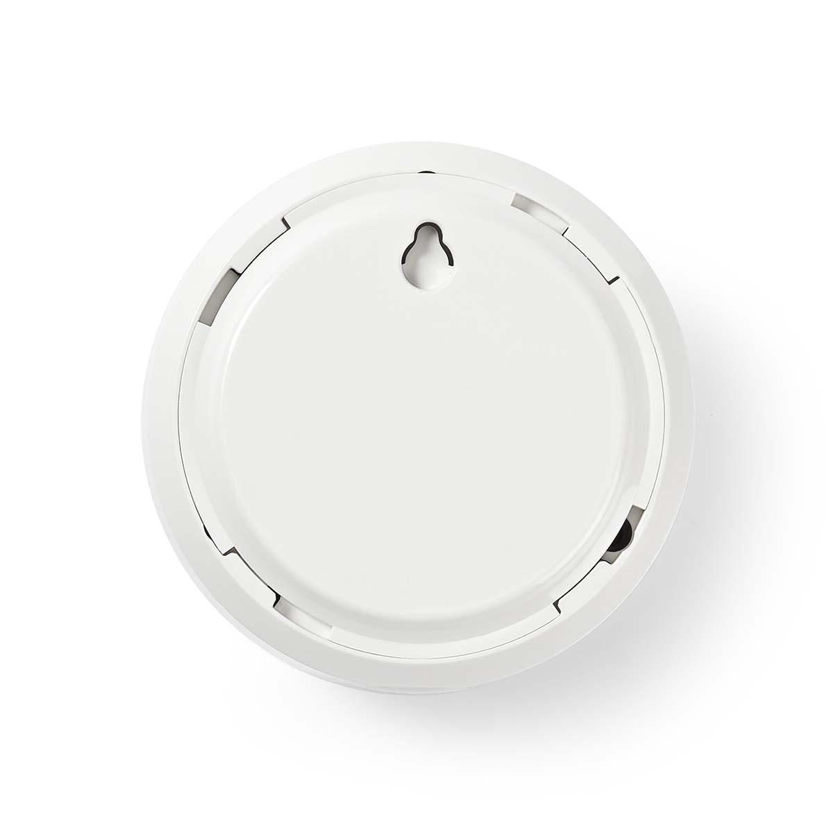 Detector de humo blanco desde arriba sobre fondo blanco.