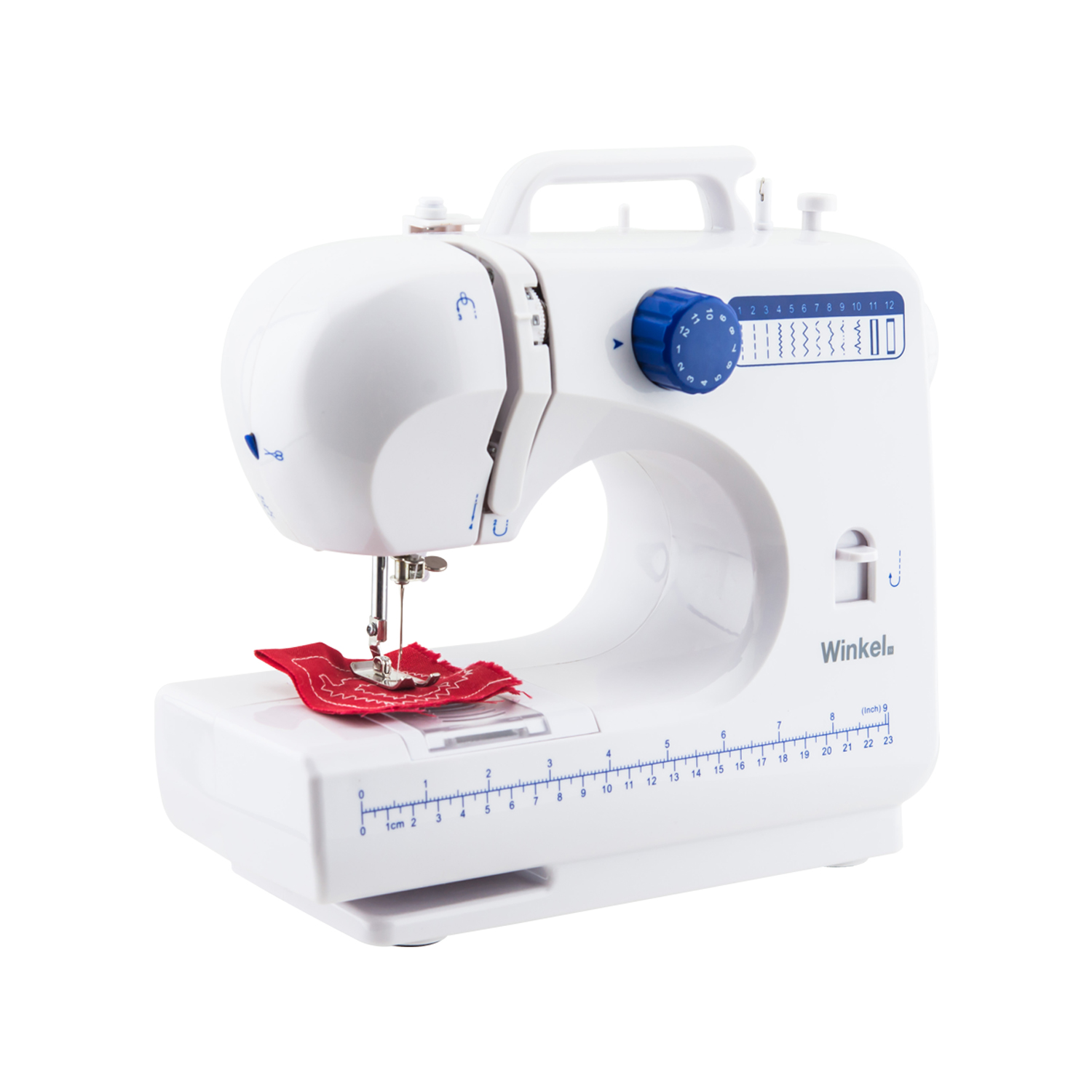 Biała maszyna do szycia z czerwoną tkaniną w trakcie szycia. Ma niebieskie pokrętło i oznaczenia linijki.