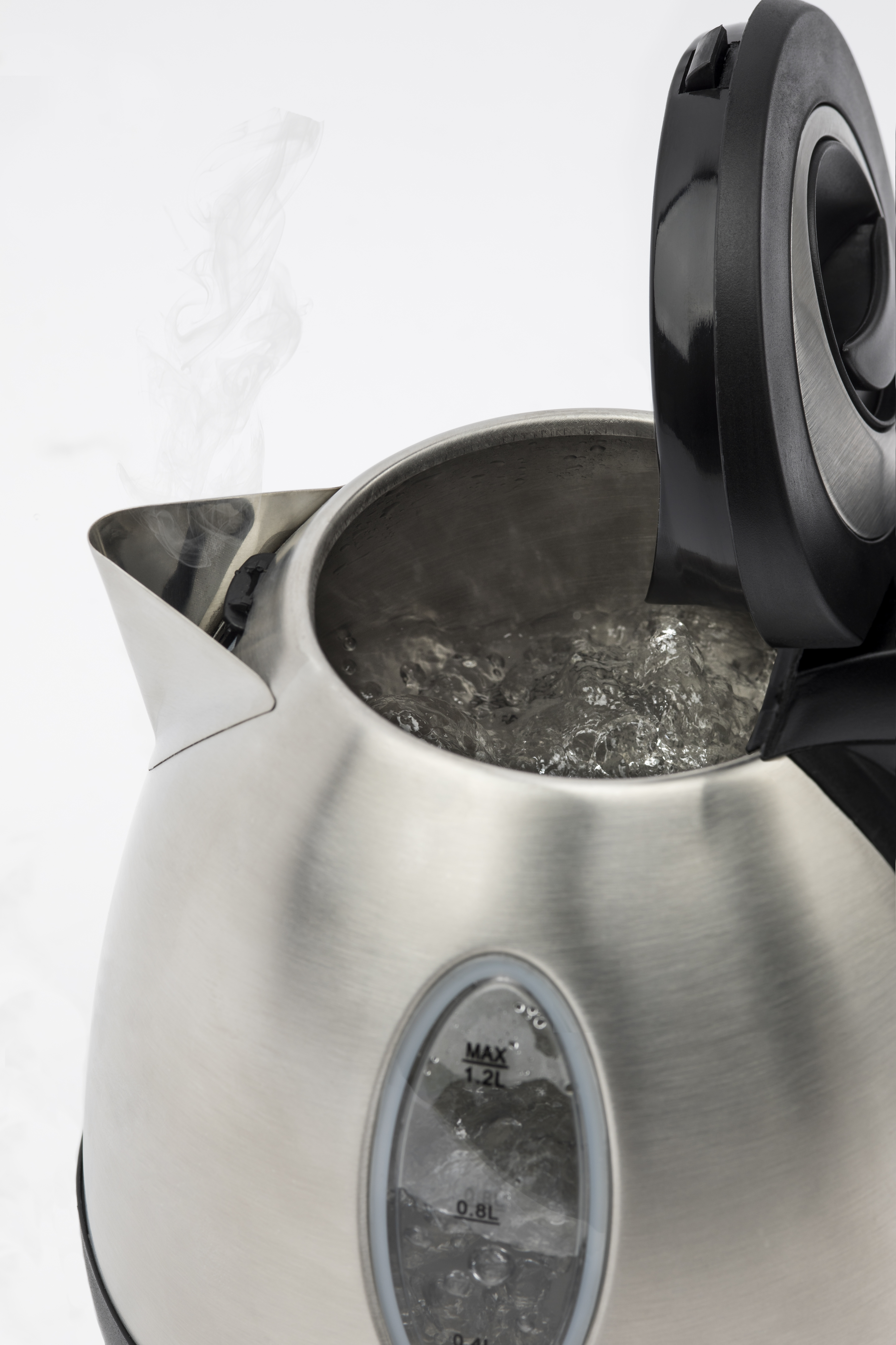 Silver kettle with steam rising, lid open, water boiling inside.