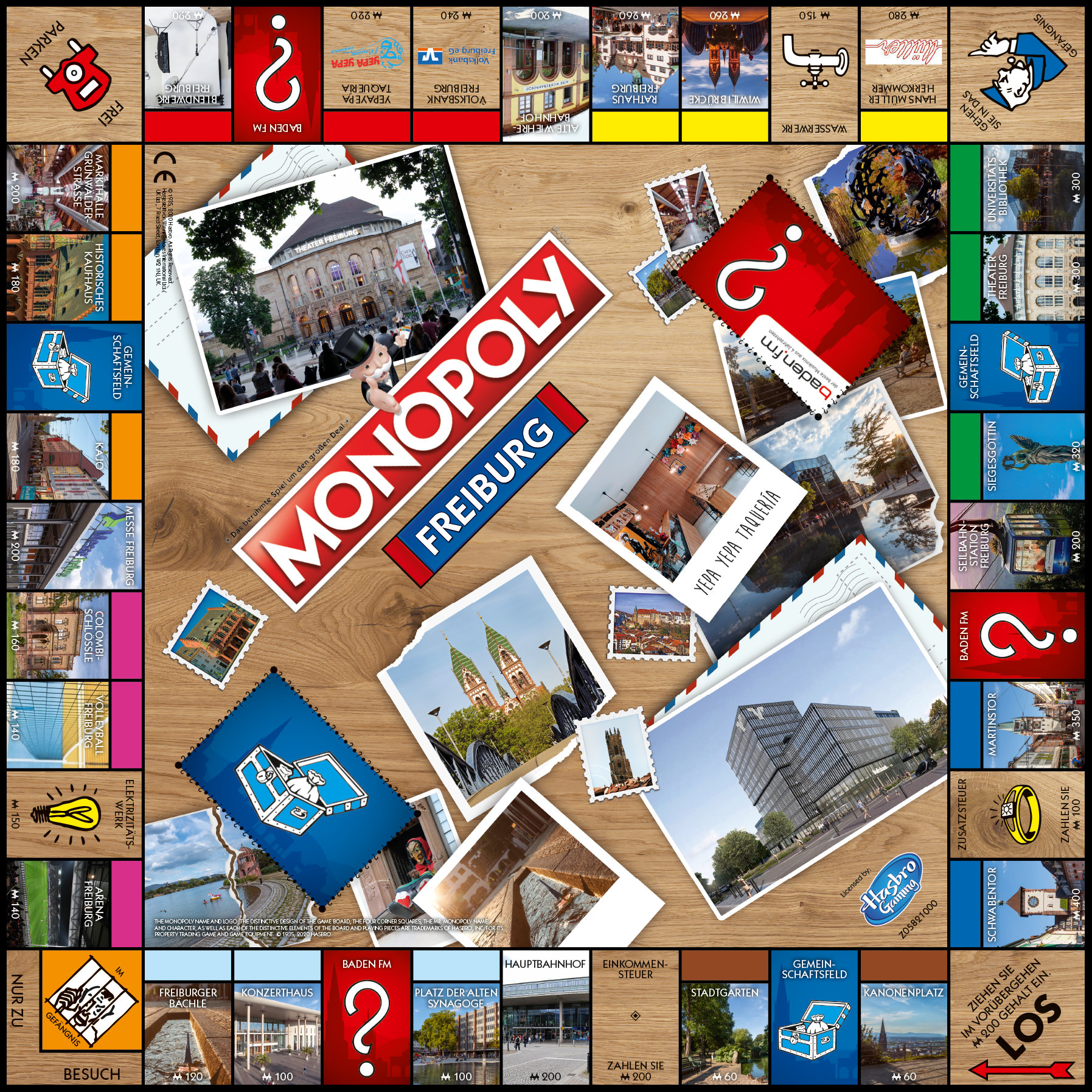 Monopoly Freiburg Brettspiel mit verschiedenen Stadtbildern und Karten auf Holzoberfläche.