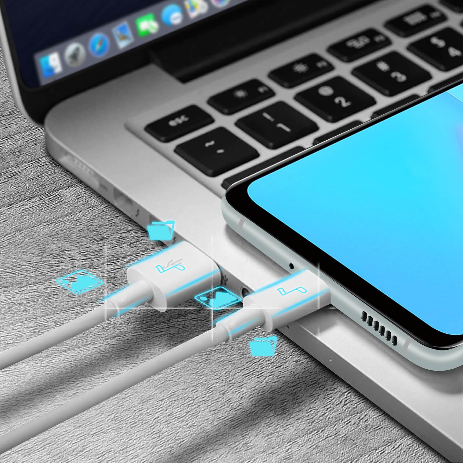 Un laptop con un telefono in carica tramite un cavo bianco. Vengono visualizzate icone blu luminose. Tasti della tastiera visibili.
