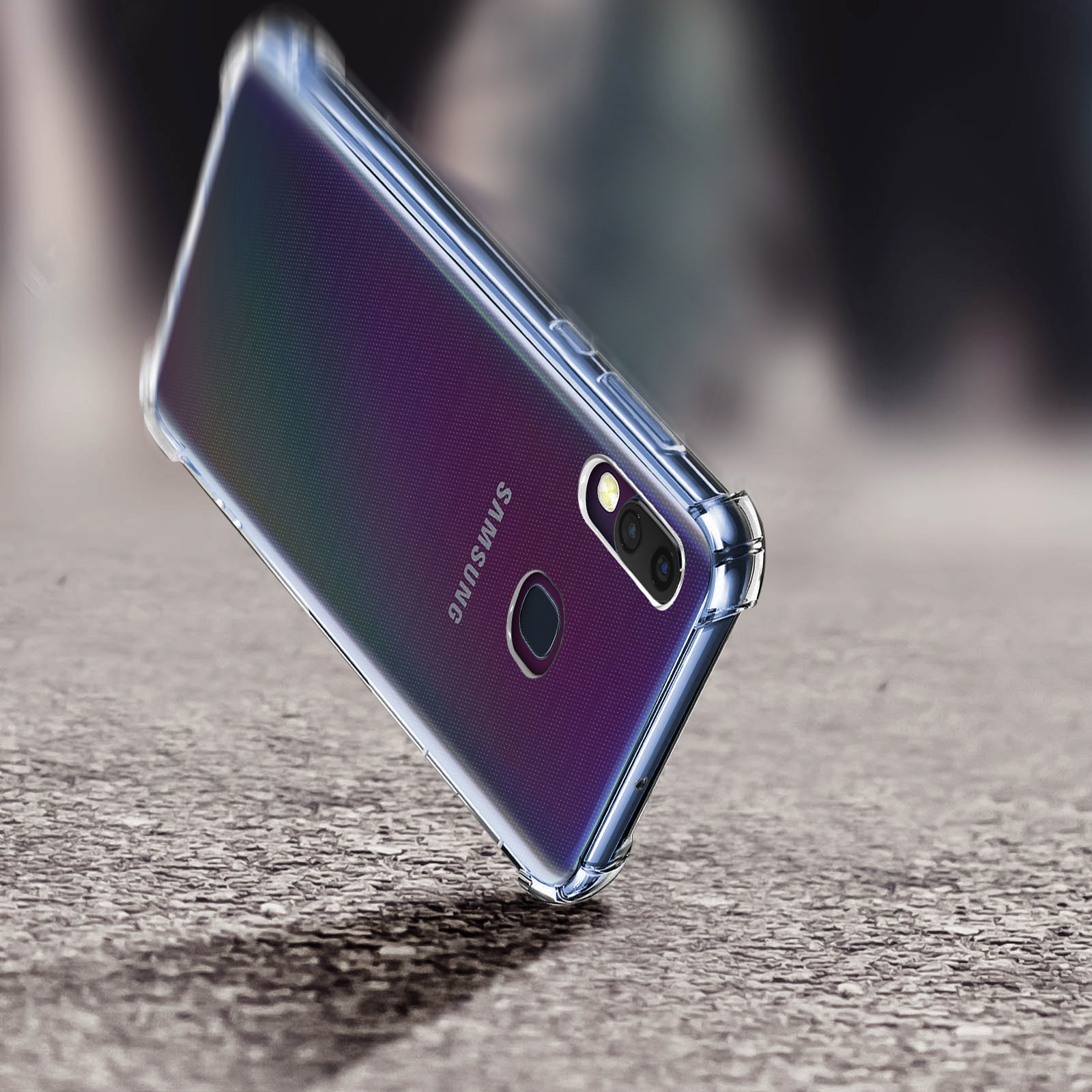 Un telefono in una custodia trasparente, inclinato e che cade su una superficie.