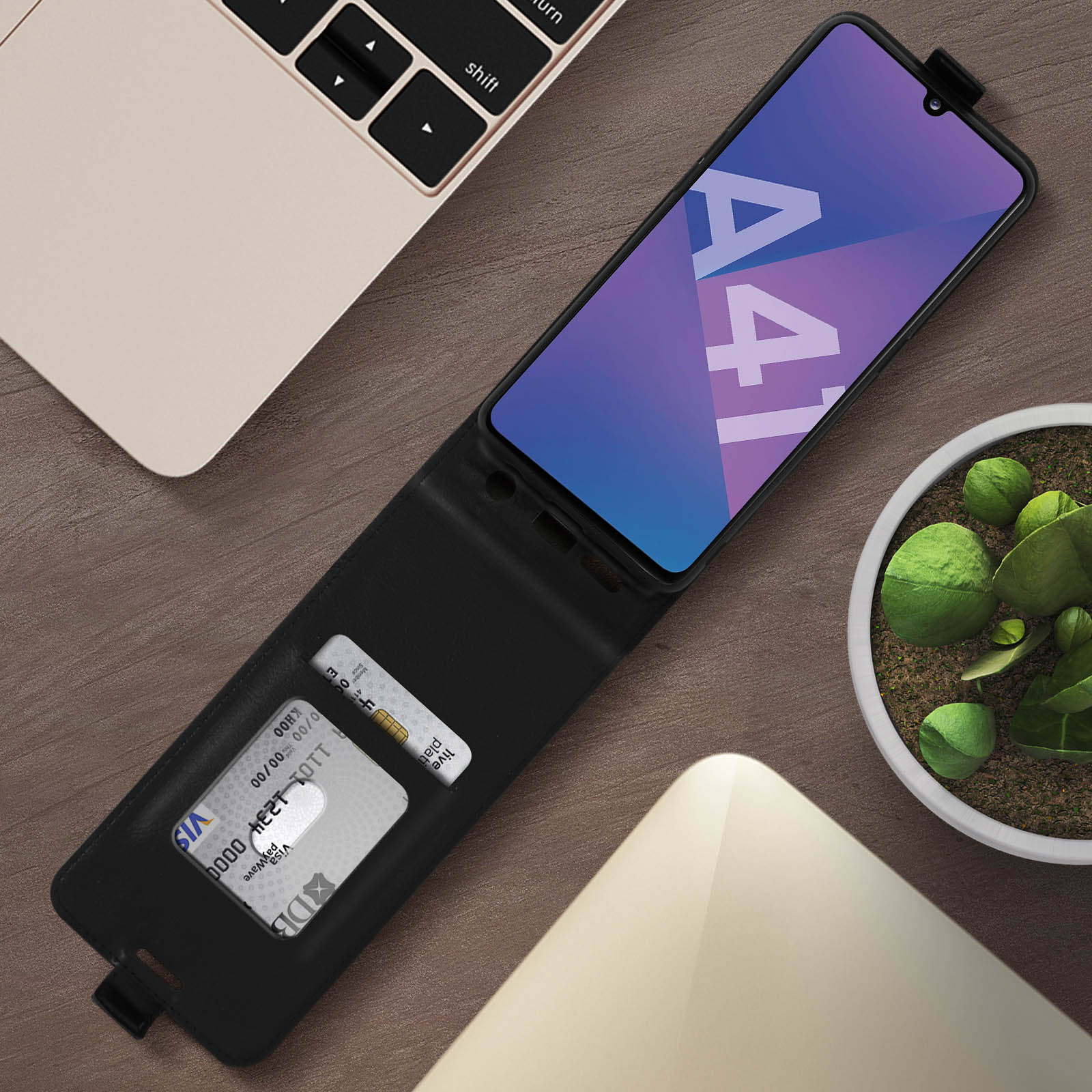 Téléphone en étui noir, ouvert avec carte, sur table en bois.