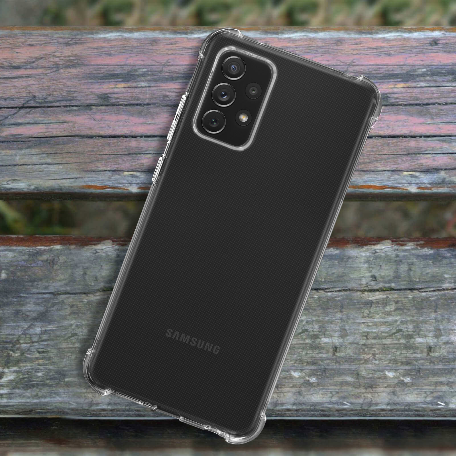 Custodia per telefono su una superficie di legno, con un telefono Samsung visibile.