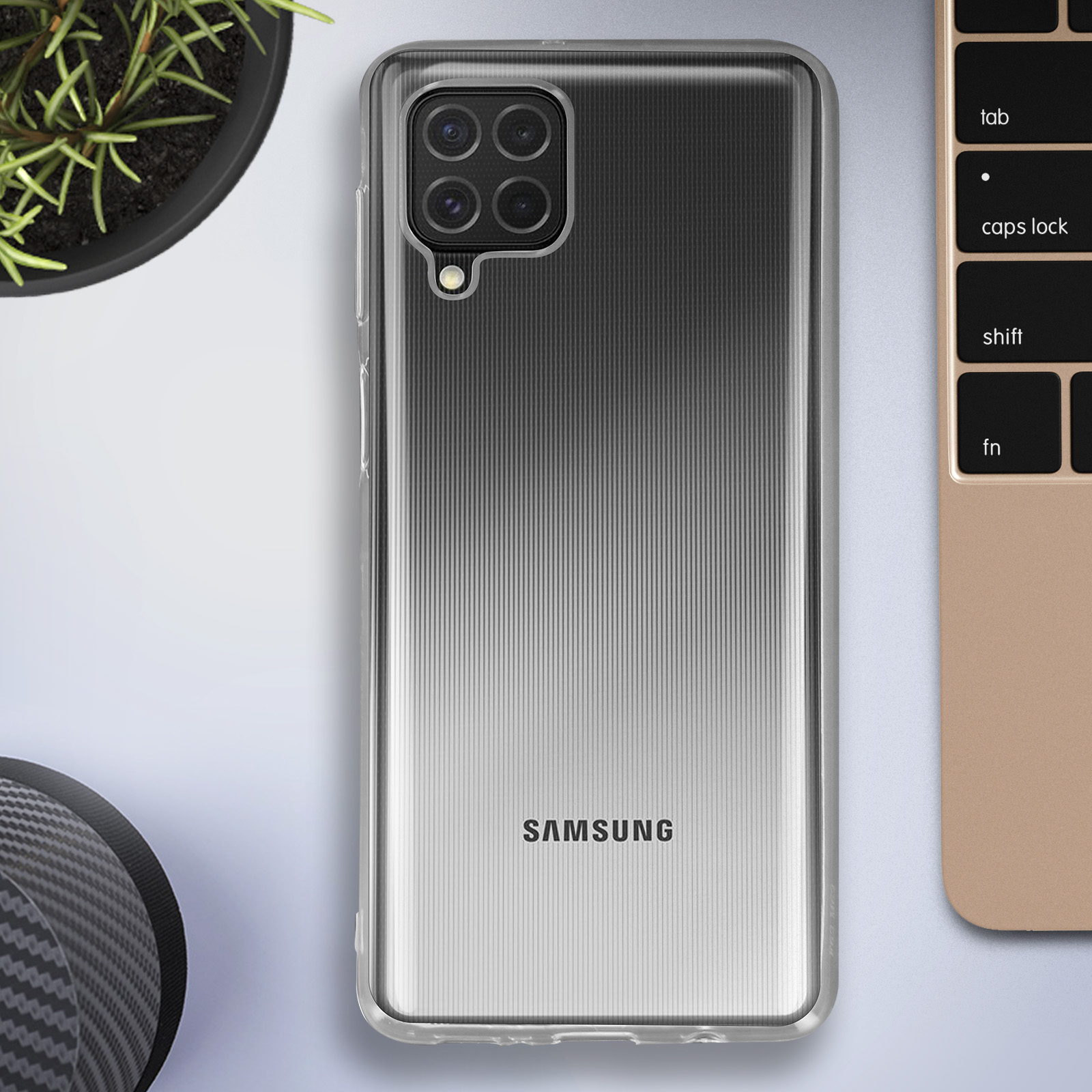 Custodia per telefono su scrivania con tastiera. Custodia a strisce. Grigio e nero.