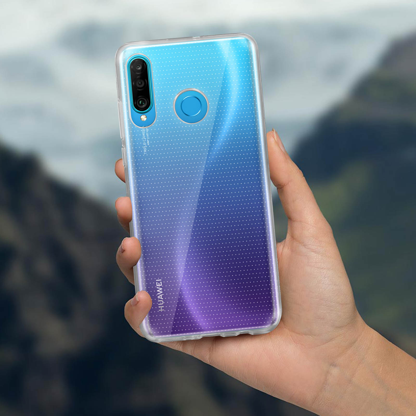 Una mano che tiene un telefono con una custodia trasparente con punti blu e viola.