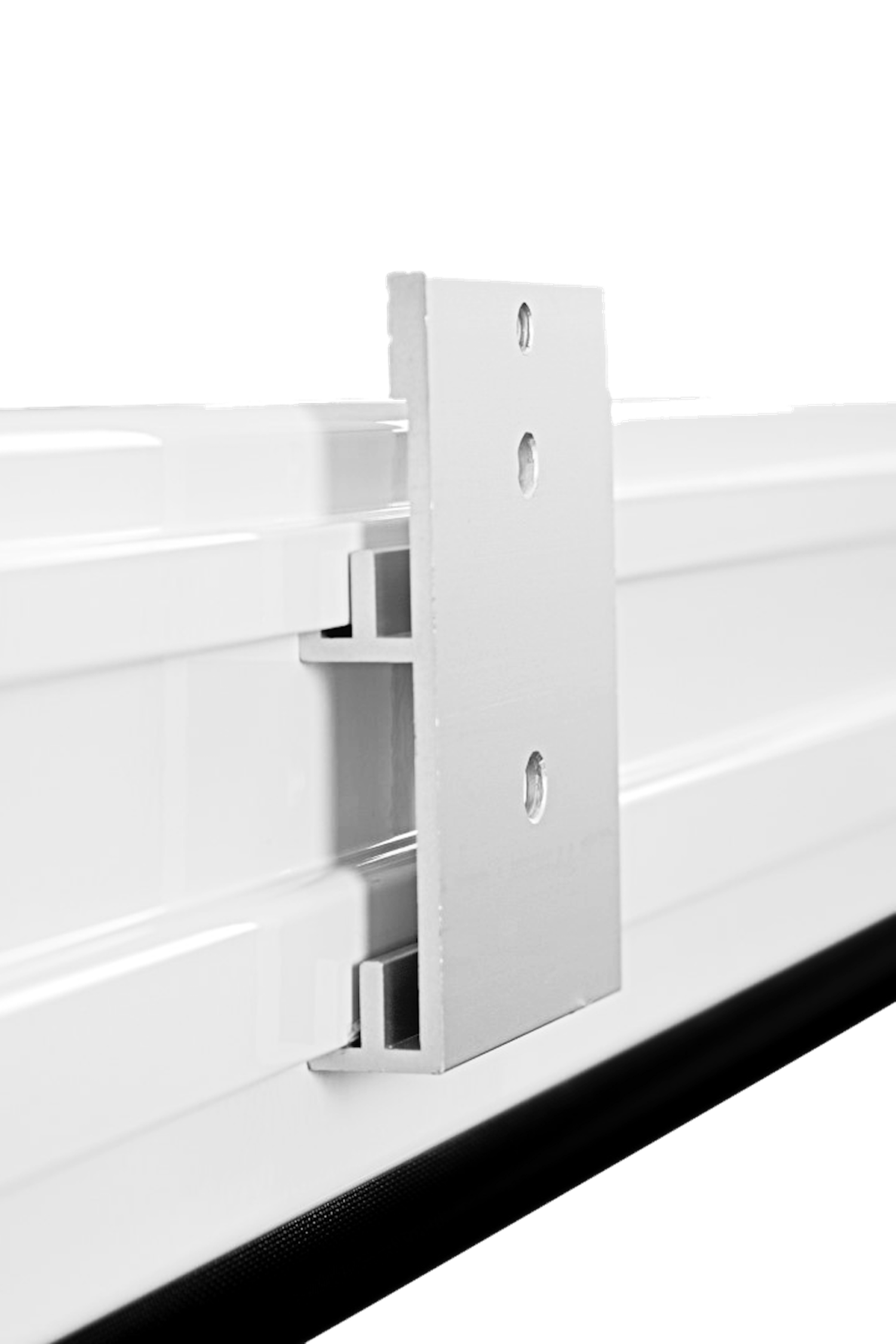 A metal bracket is attached to a white surface. It has holes for screws.