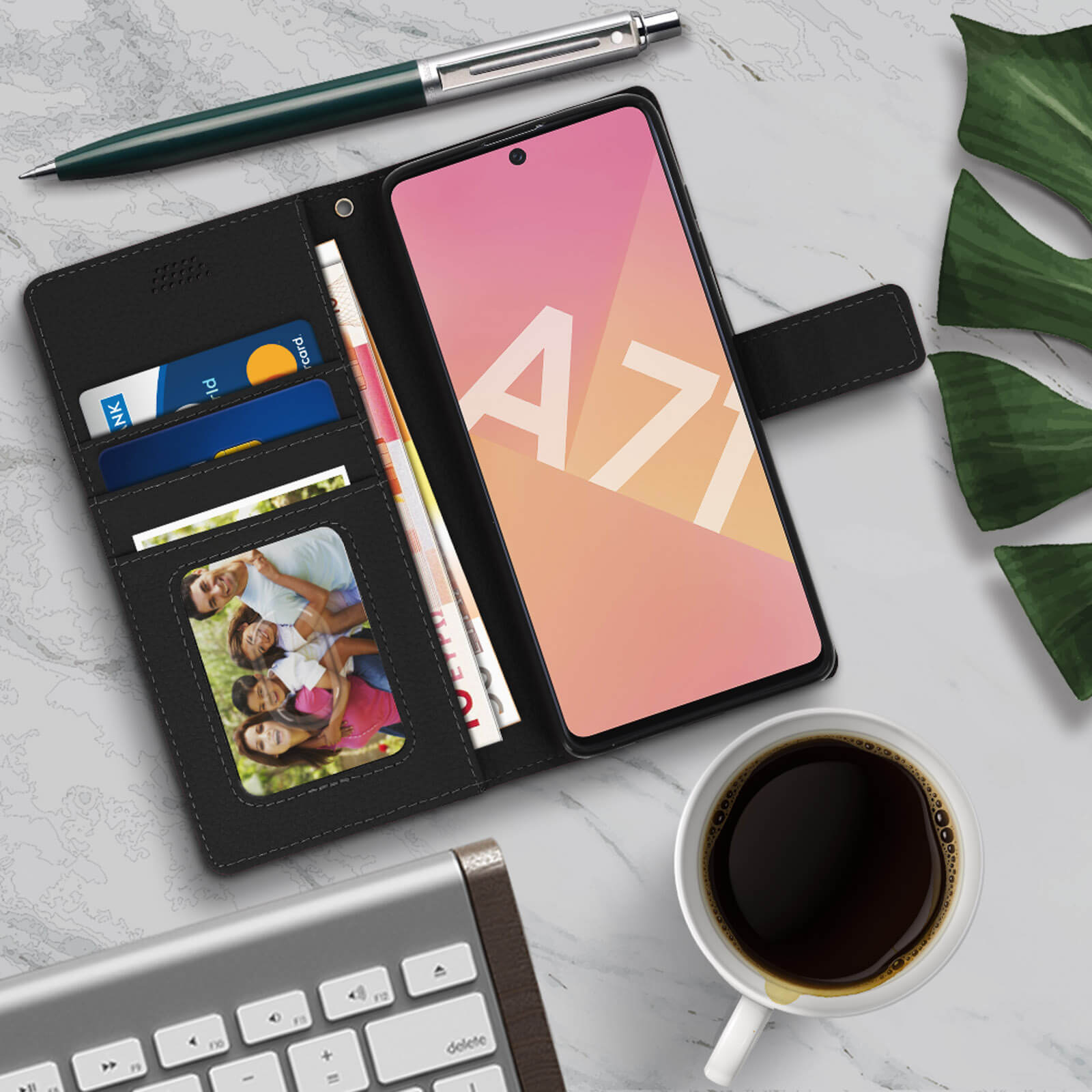 Un telefono in una custodia a portafoglio nera aperta, con foto di famiglia, carte, soldi e tazza di caffè.