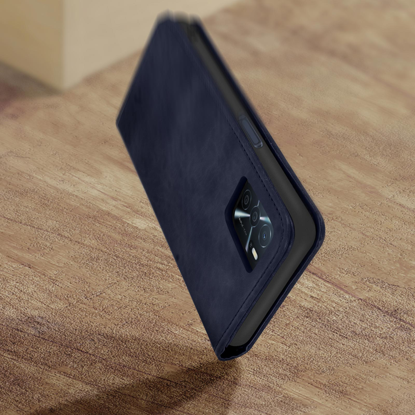Custodia per telefono blu scuro su una superficie di legno, telefono parzialmente visibile.