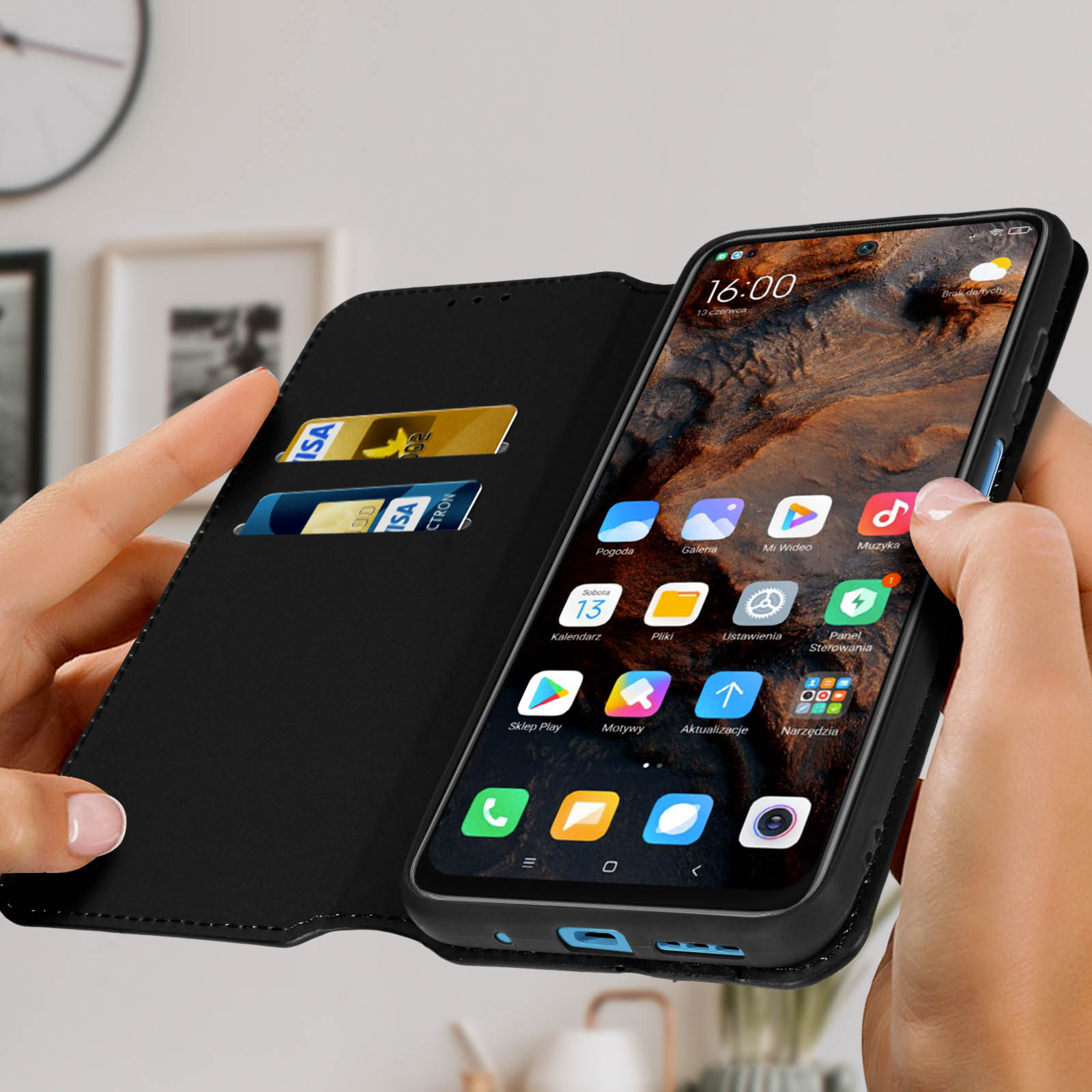 Téléphone dans un étui noir, montrant une interface avec des applications et des cartes de crédit dans la couverture.