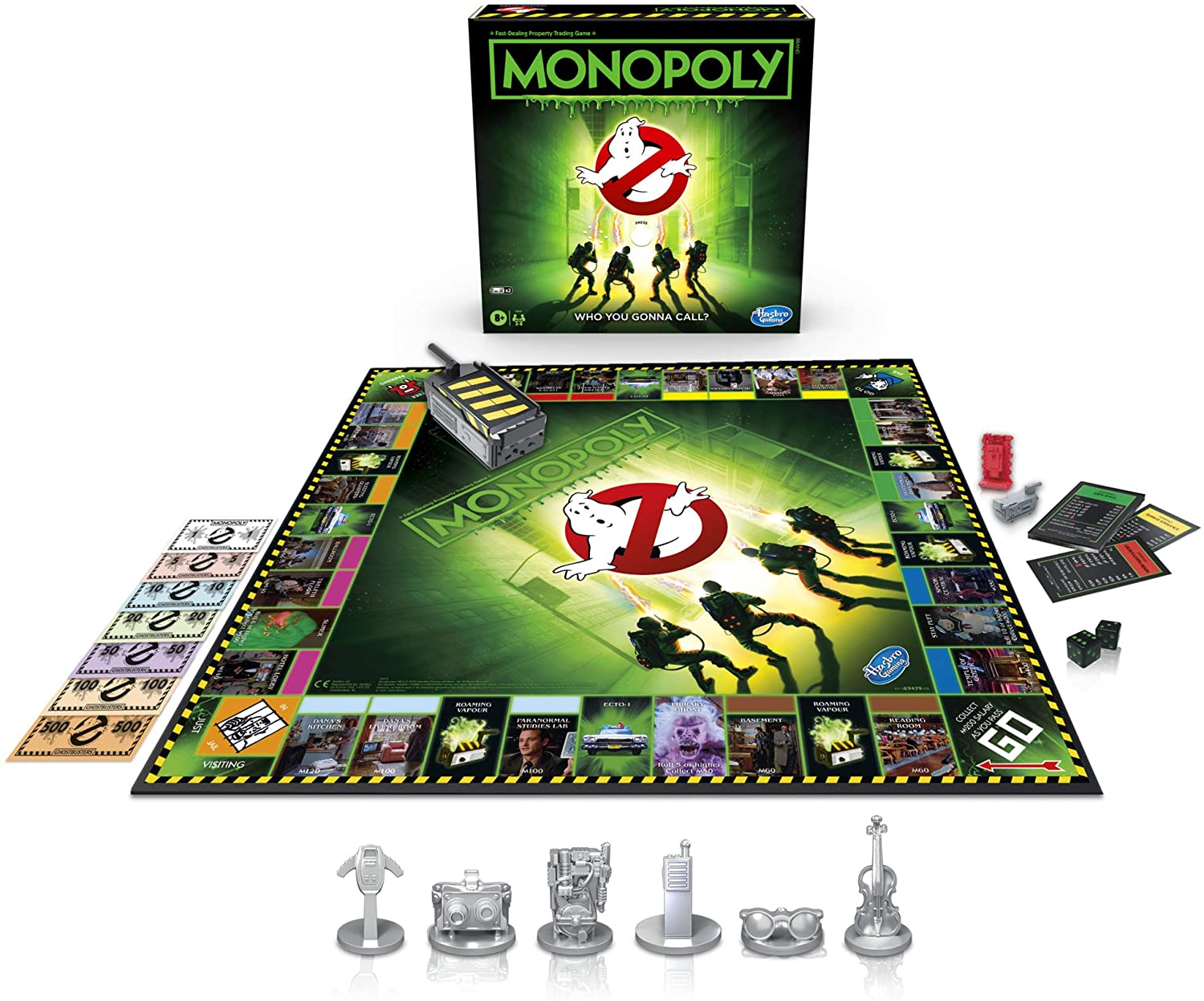 Monopoly-Brettspiel mit Ghostbusters-Thema. Spielfiguren und Karten sind sichtbar. Die Box ist oben.